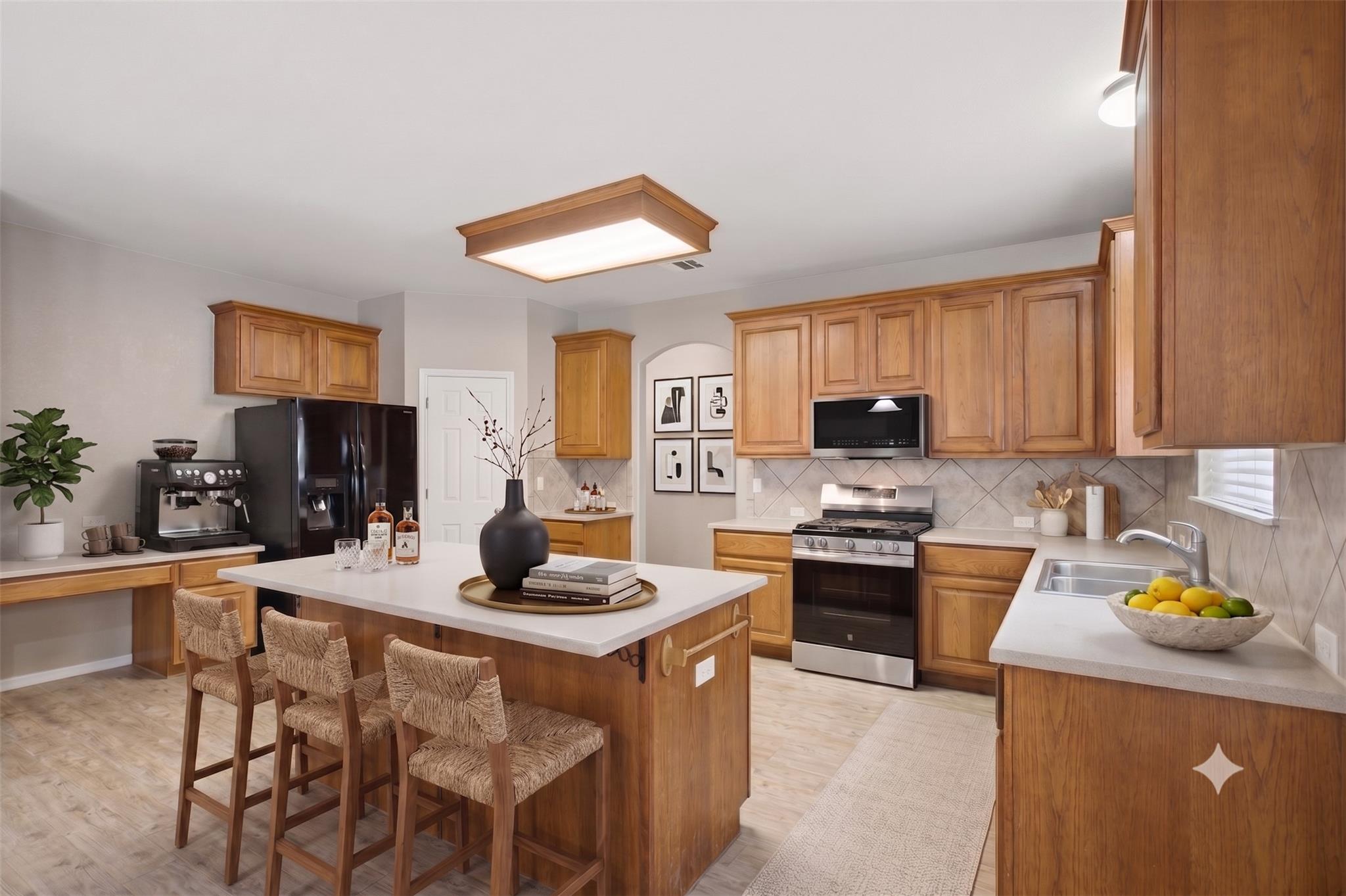 A well-appointed kitchen features natural wood ca
