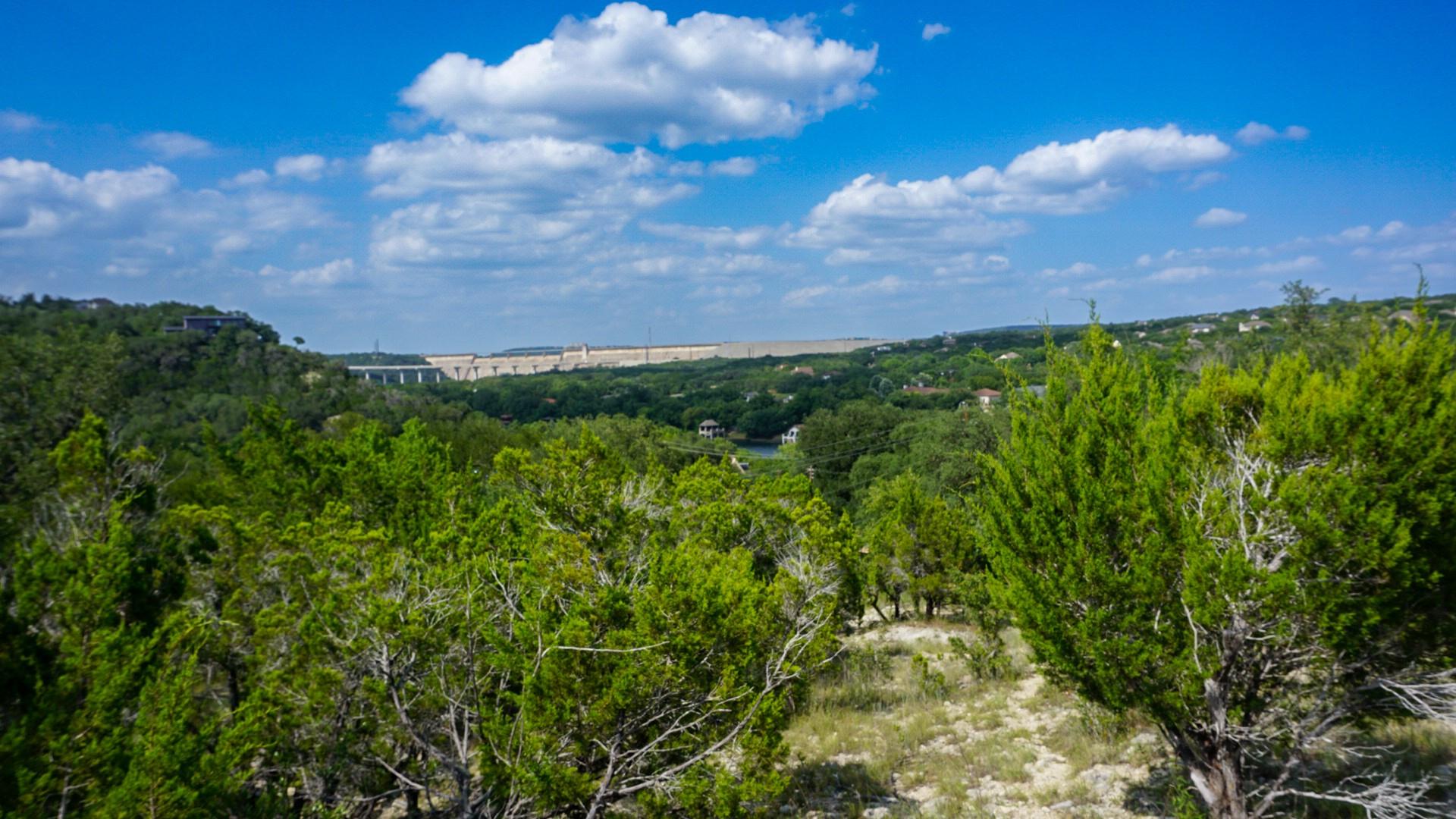 A sweeping panorama captures distant hills and a 
