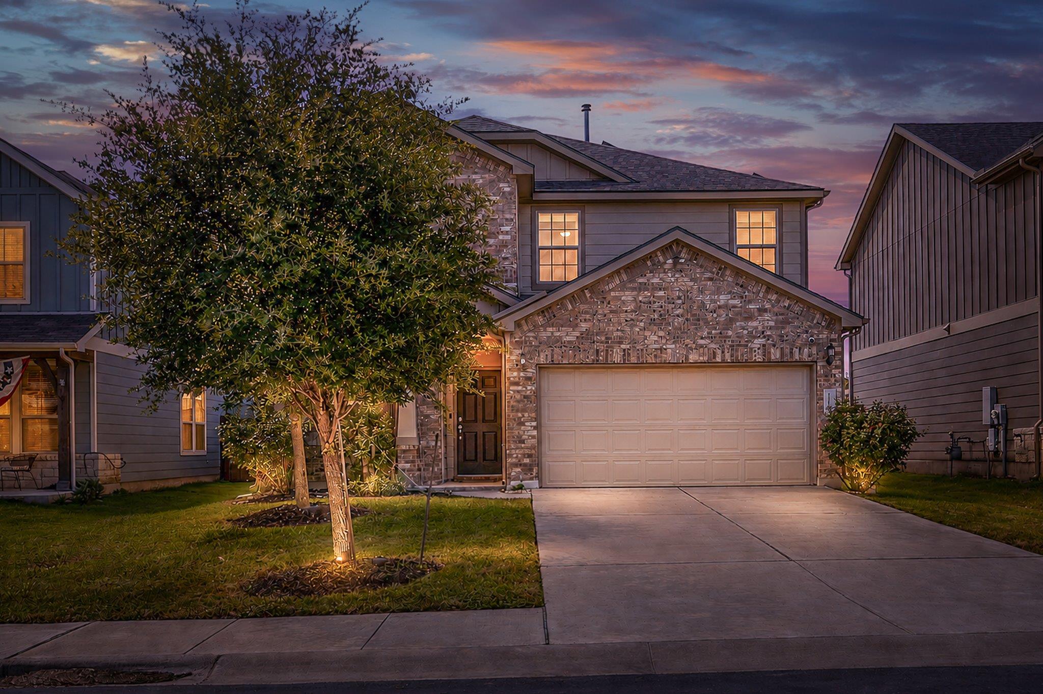 Illuminated by evening lights, this two-story res