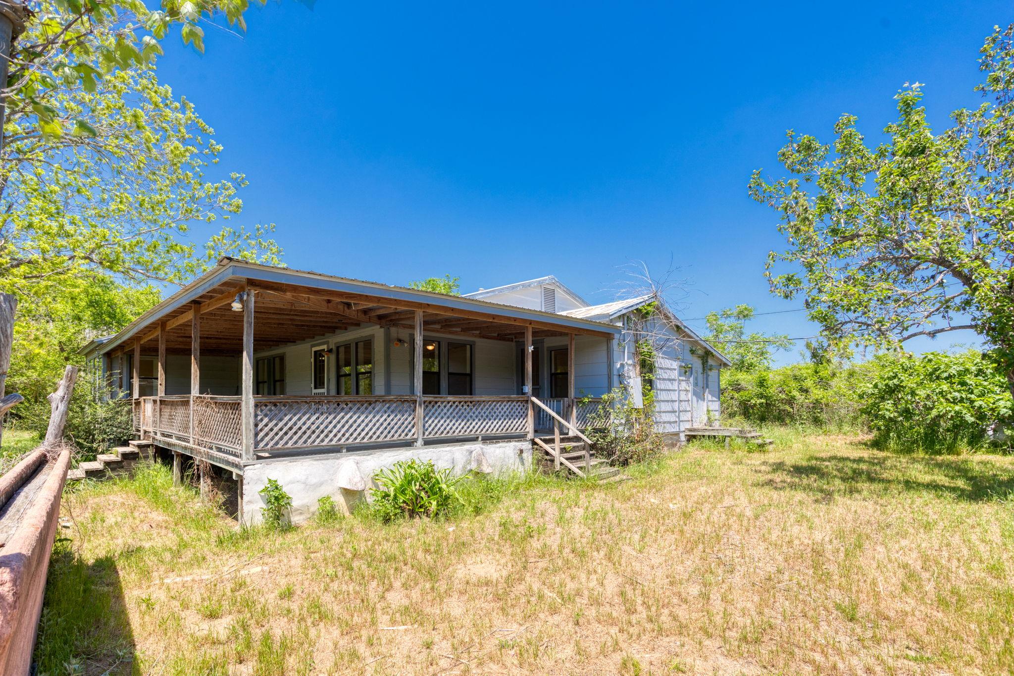 A welcoming covered porch extends across this qua