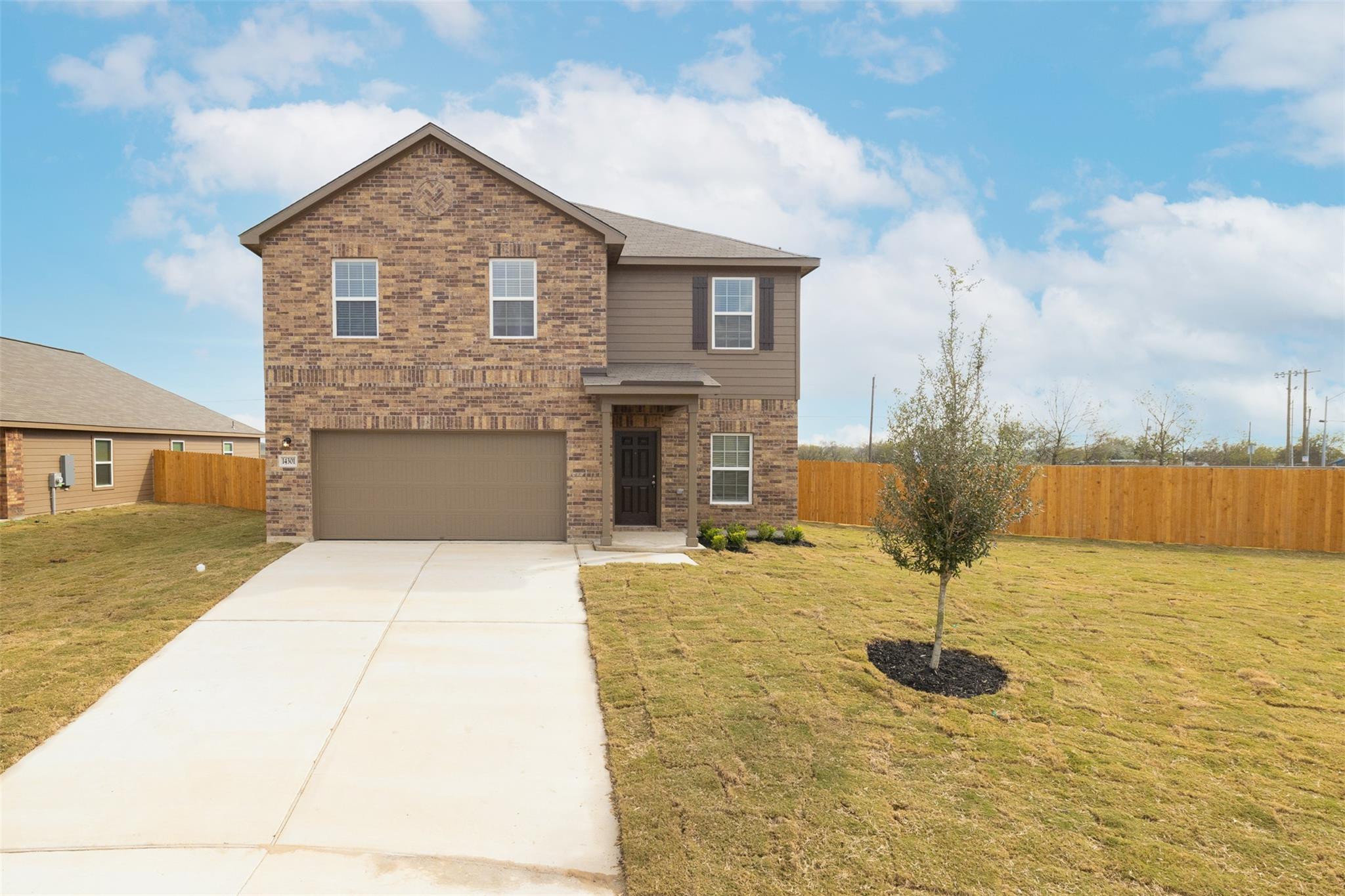 A newly constructed two-story home with a brick a