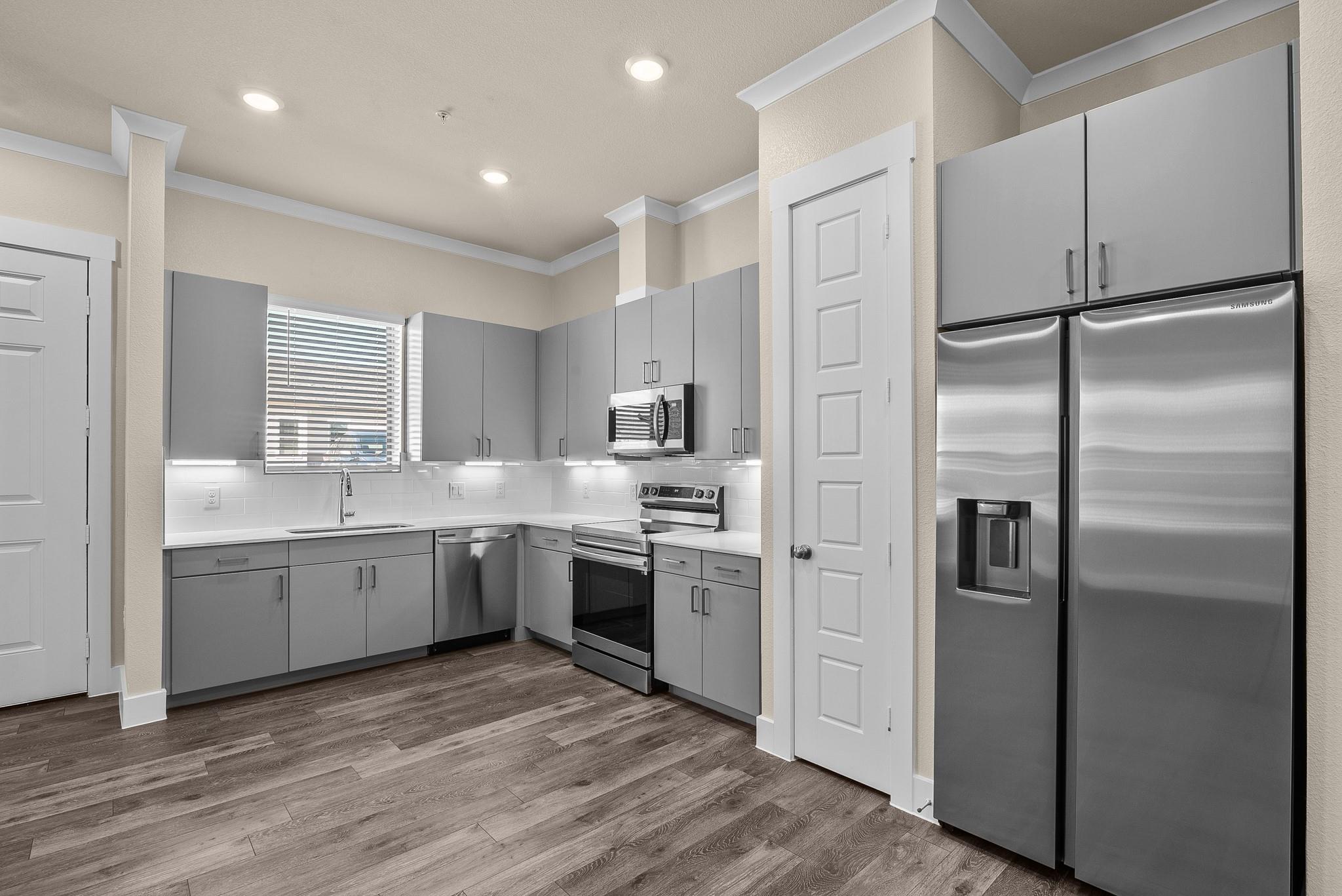 Kitchen featuring gray cabinets, stainless steel 