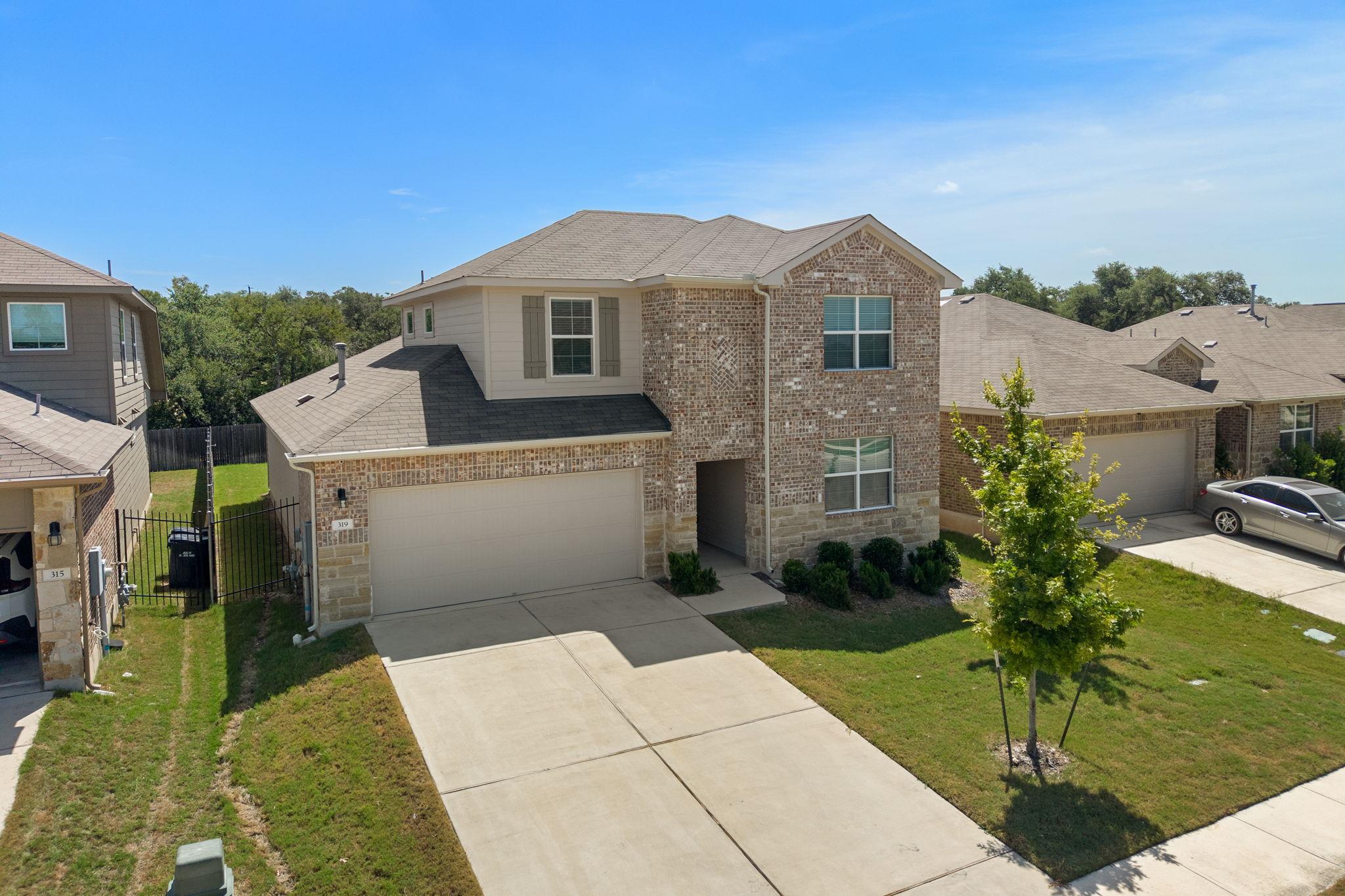 A well-maintained two-story home features a brick