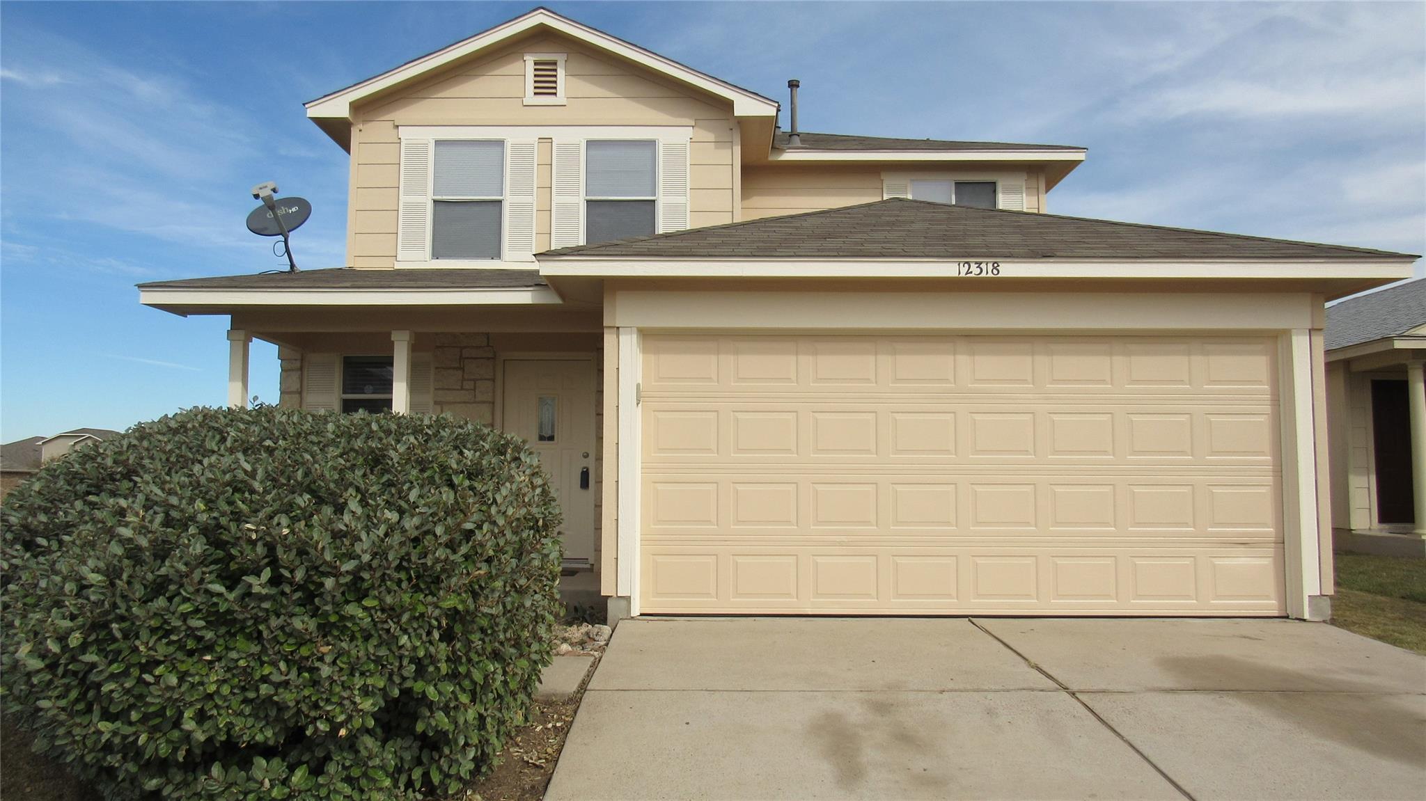 A welcoming facade with a garage, inviting you ho