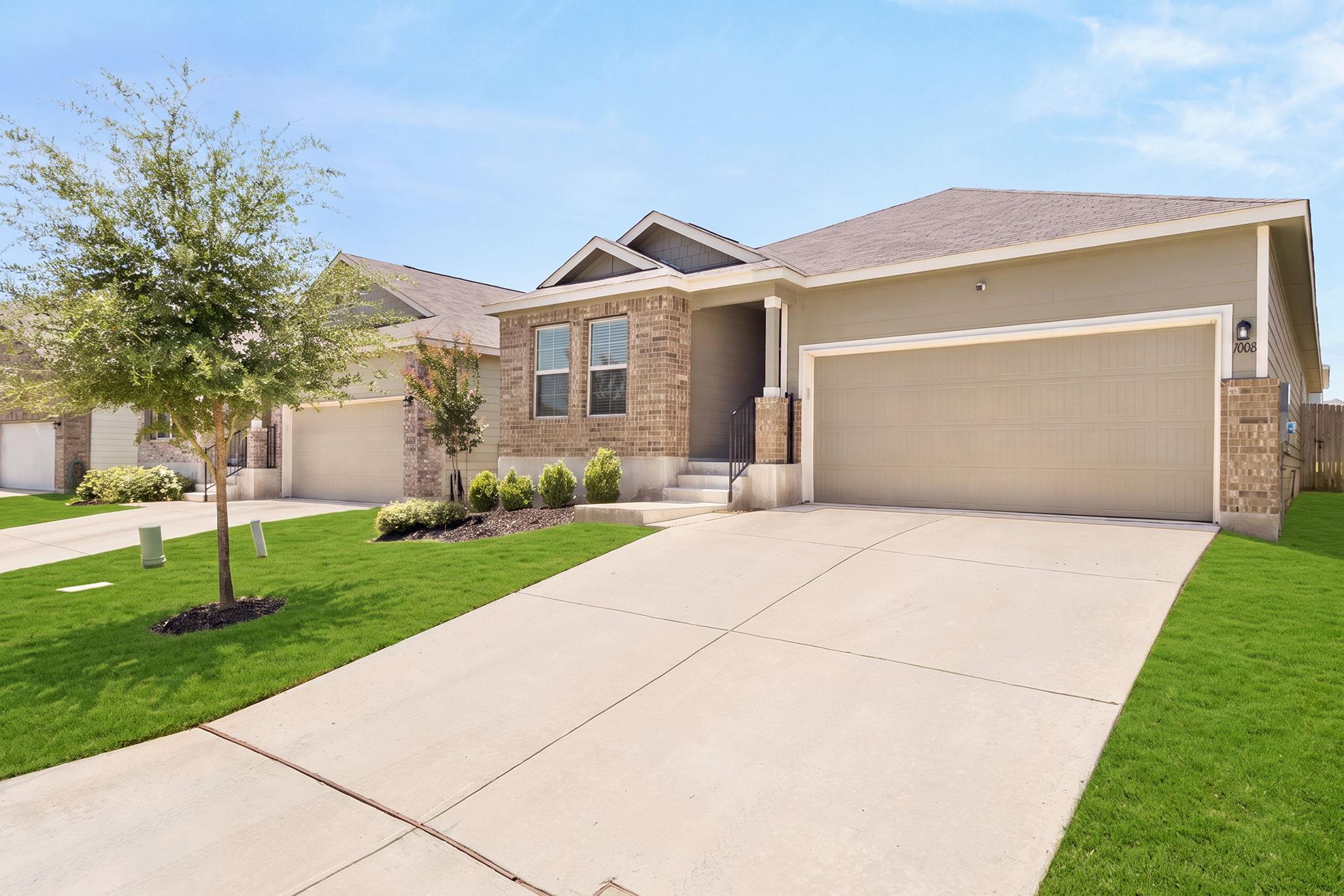 A well-maintained lawn and extended driveway enha