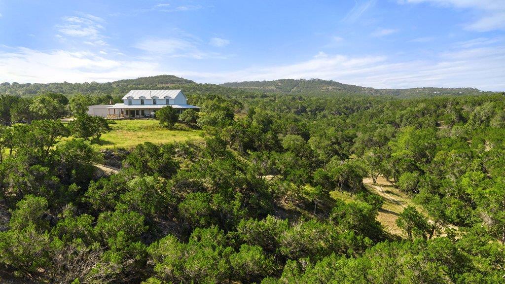 Perched on a verdant hillside, this residence off