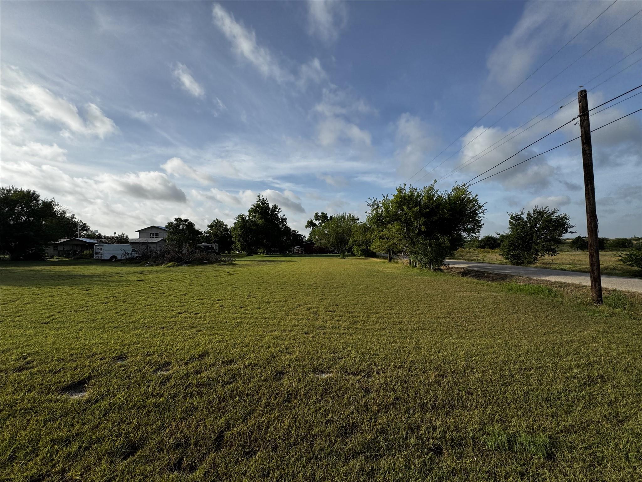 A verdant, open lot offers ample space for buildi