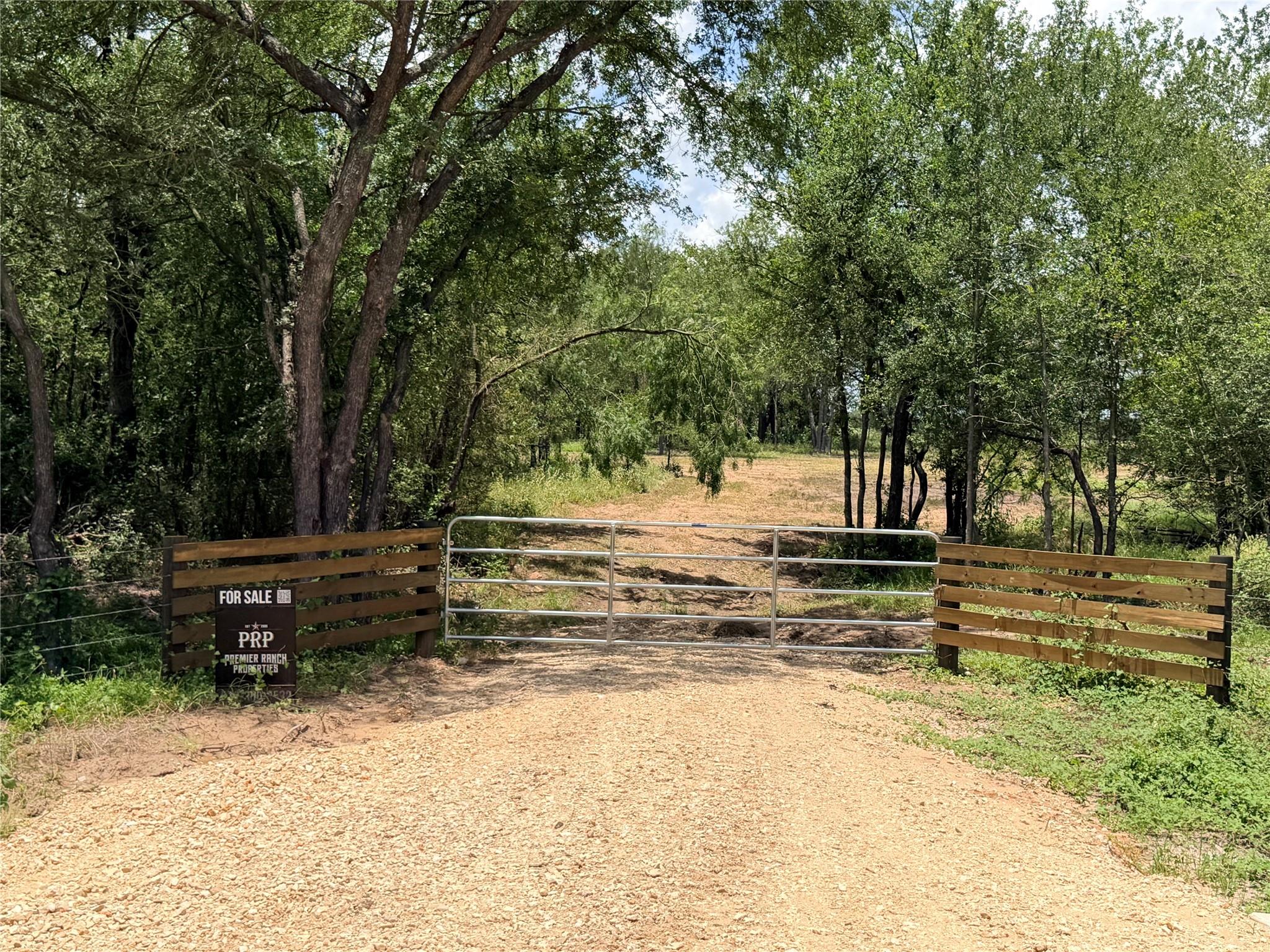 A private gravel driveway leads to an expansive, 