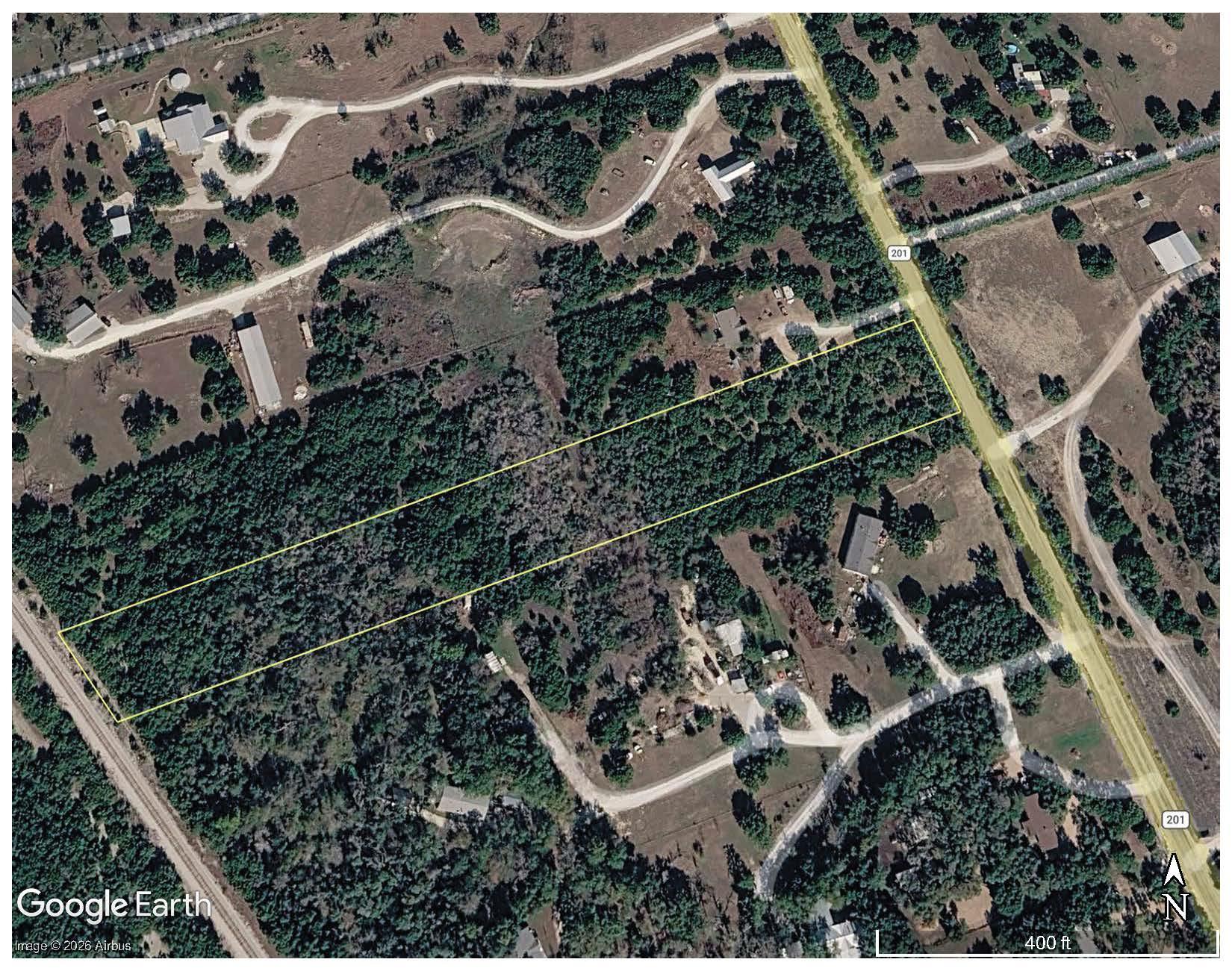 A Google Earth aerial view of a heavily treed lot