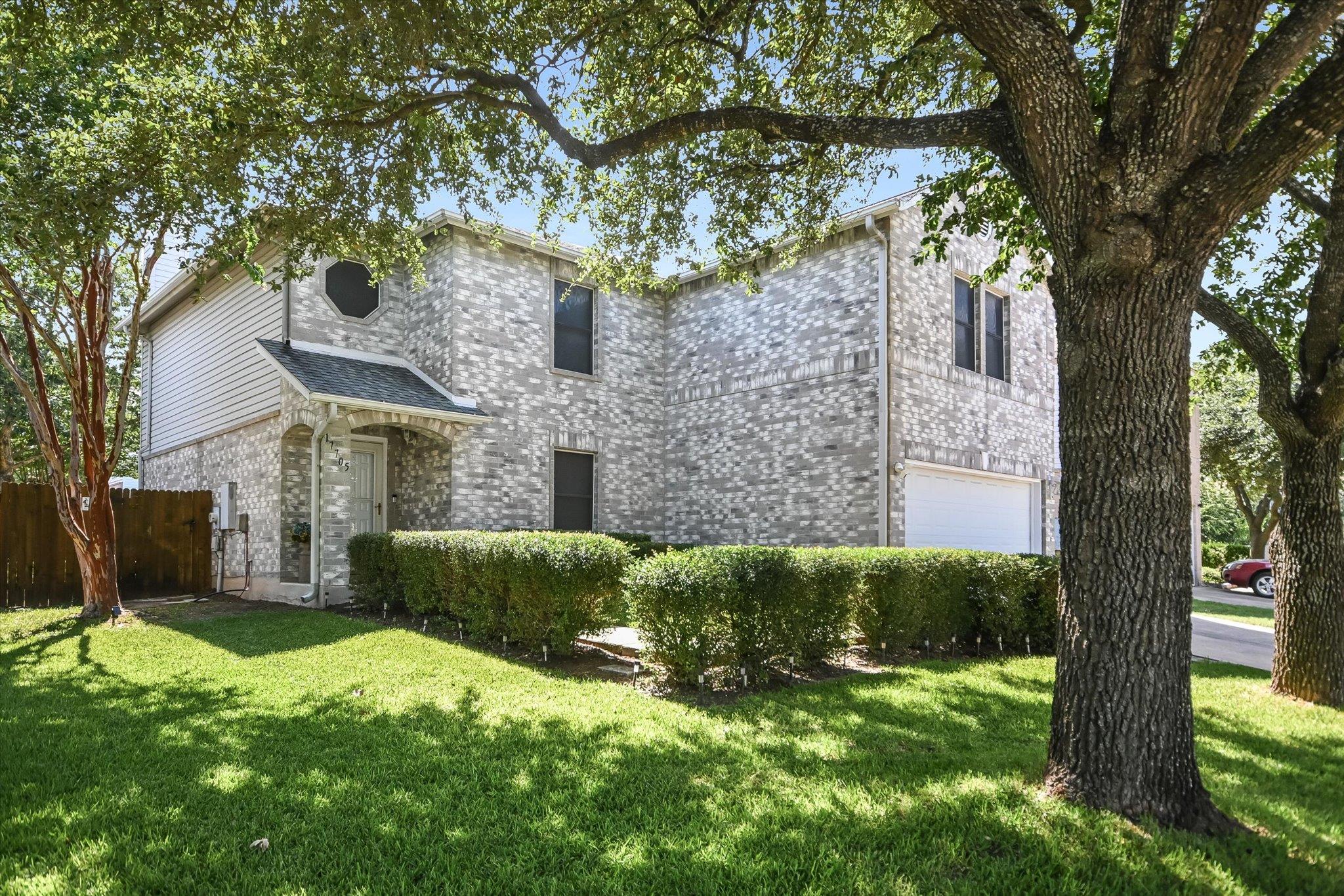 Mature trees shade this charming residence with a