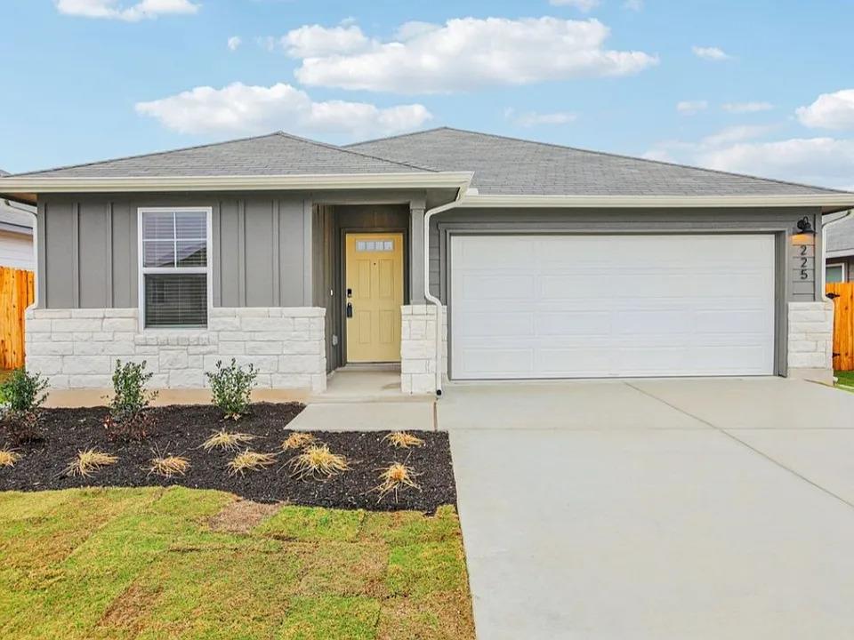 A welcoming facade boasts a vibrant yellow door a
