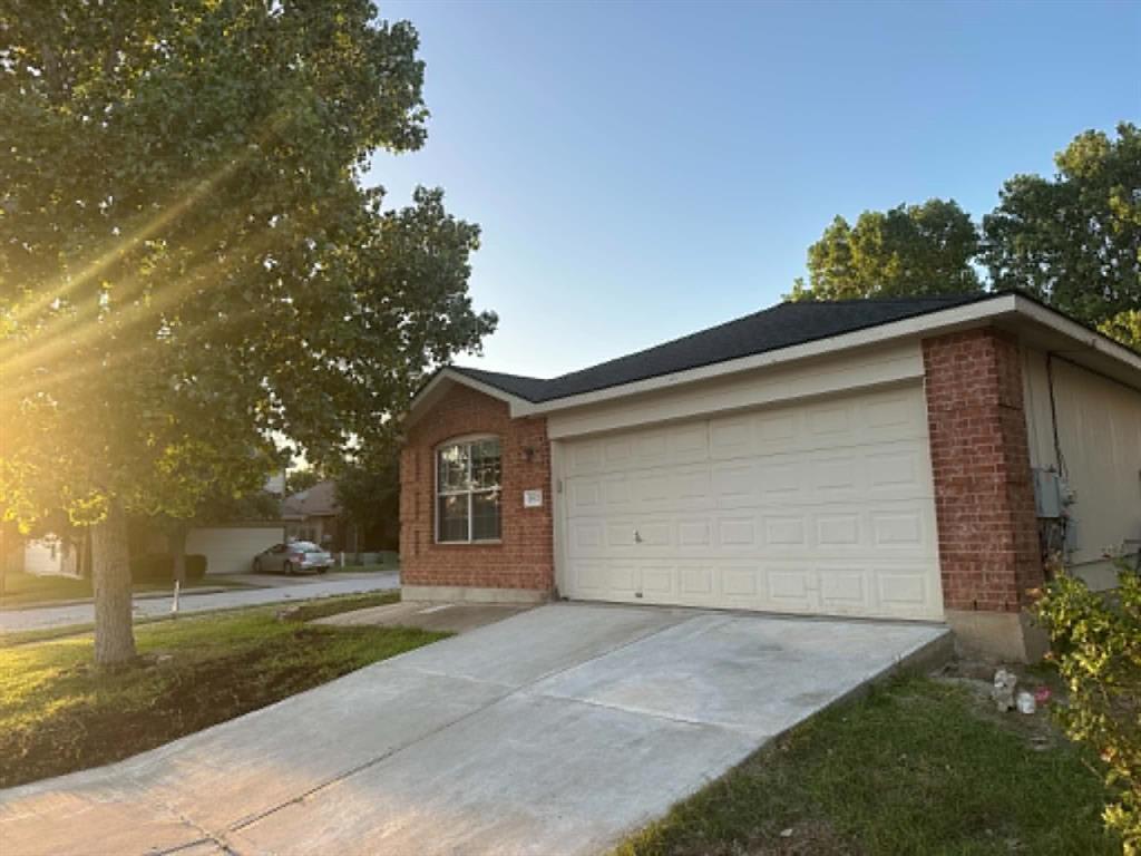 A classic brick exterior with an attached garage 