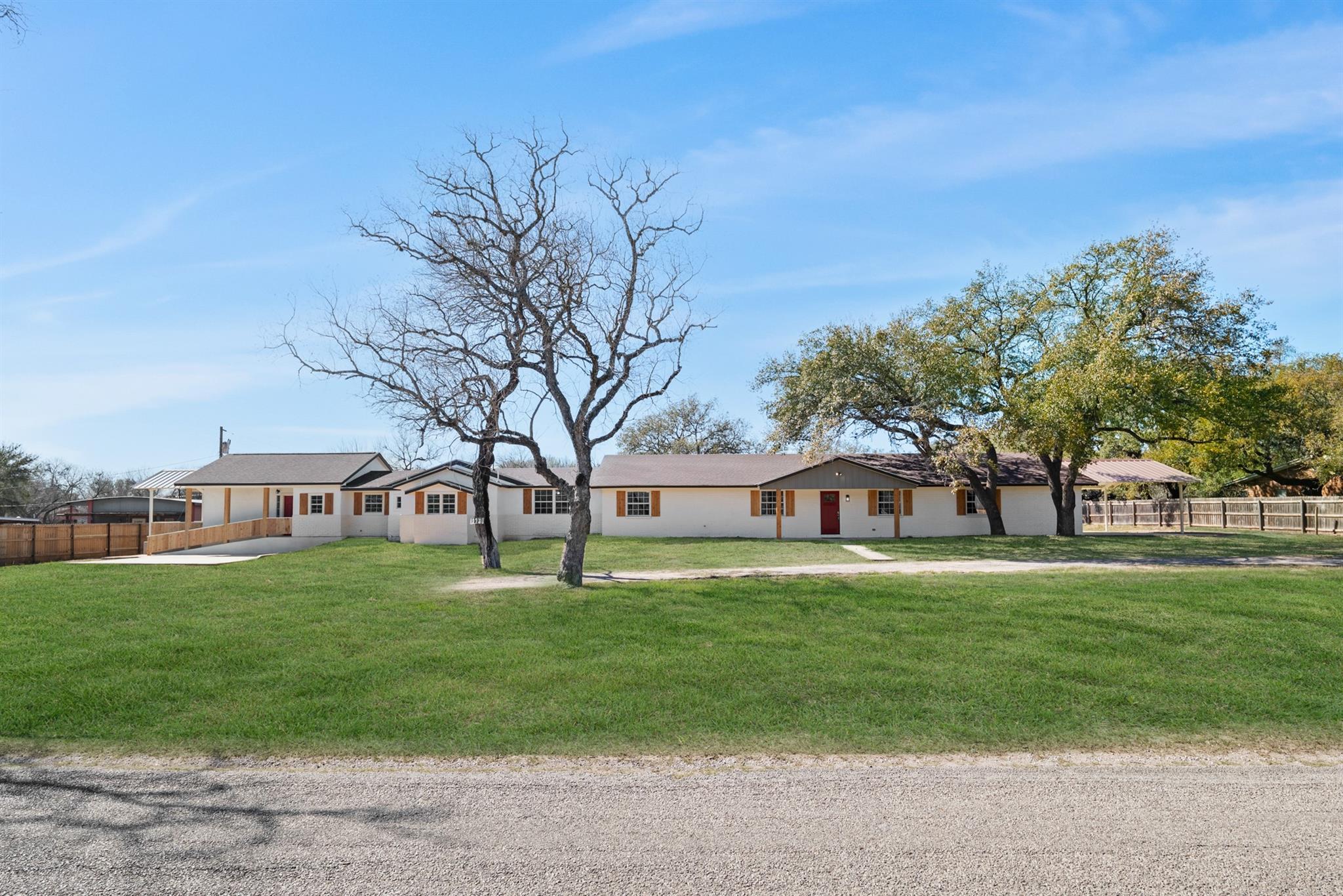 A well-maintained facade with ample green space o