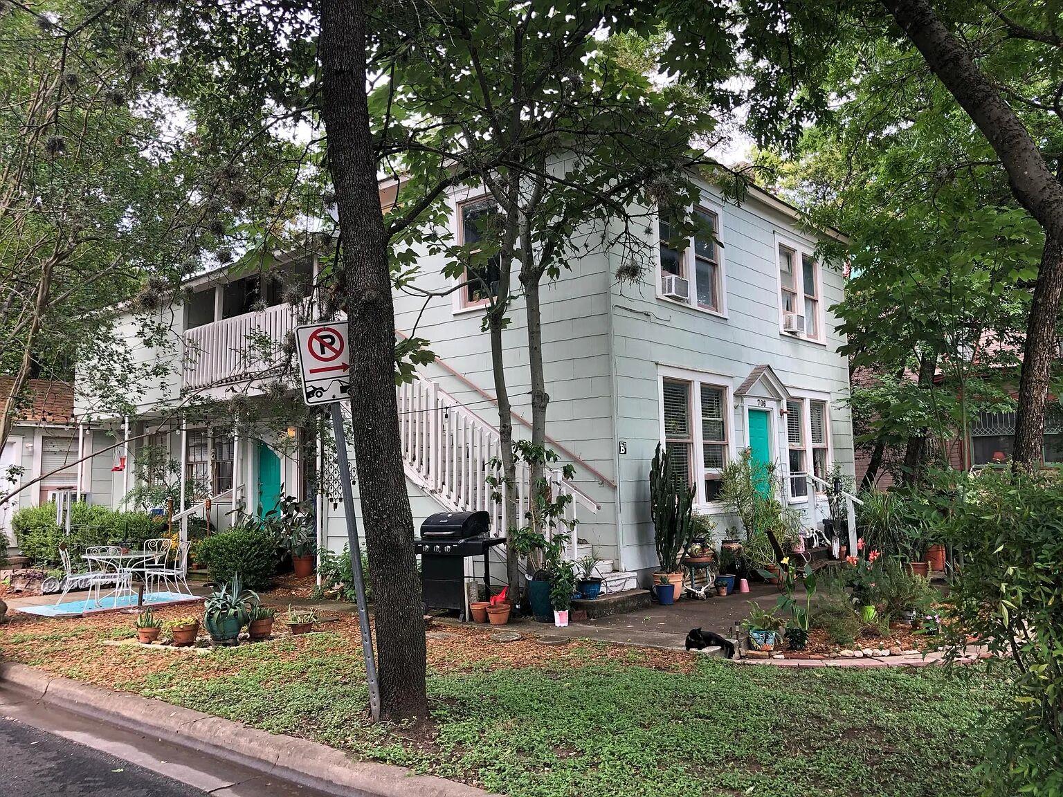 A charming multi-story home with mature trees and