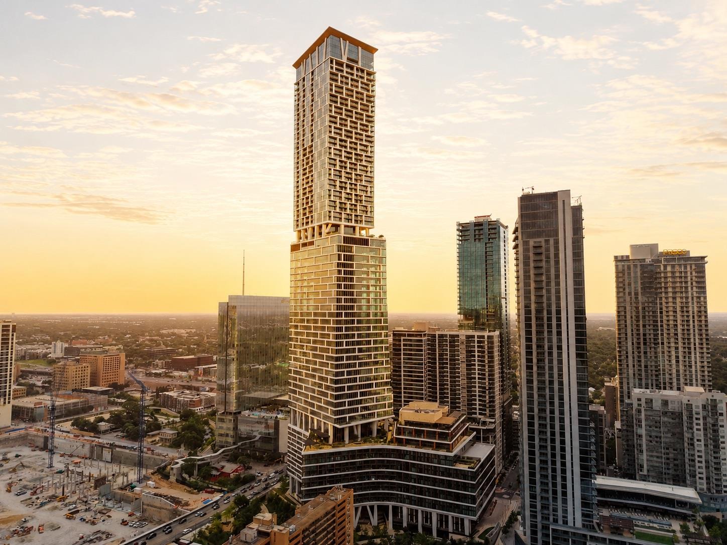 A soaring glass tower commands the city skyline u