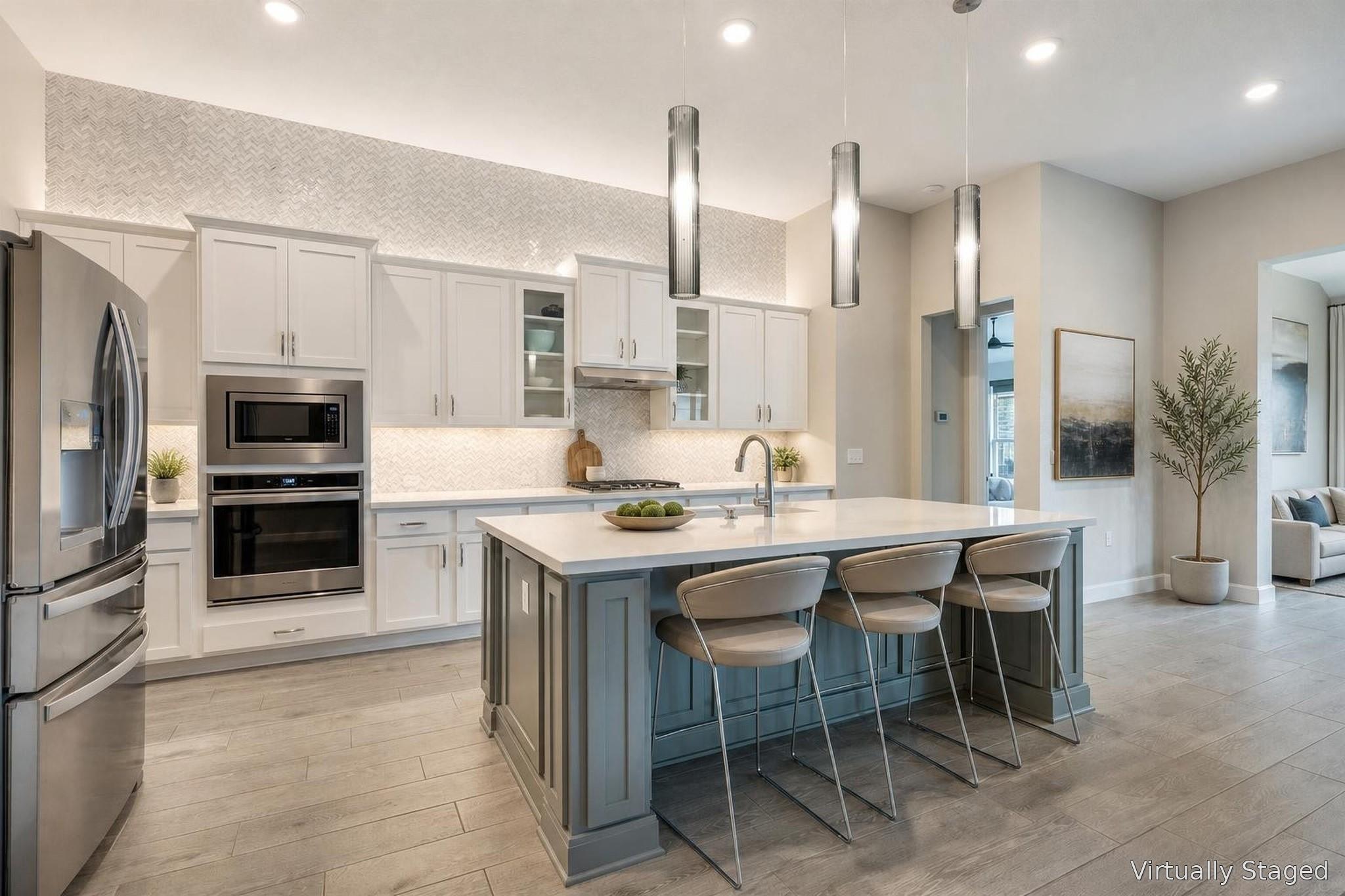 A contemporary kitchen features an inviting islan