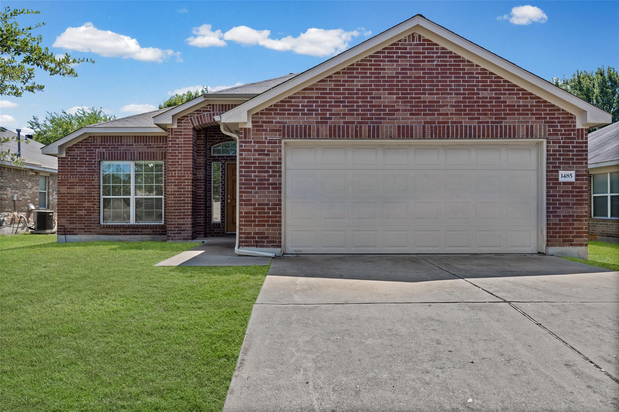 A well-maintained brick facade home awaits with a