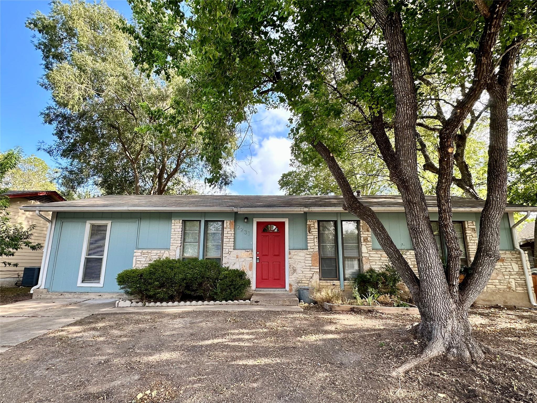 Mature trees shade this charming single-story hom
