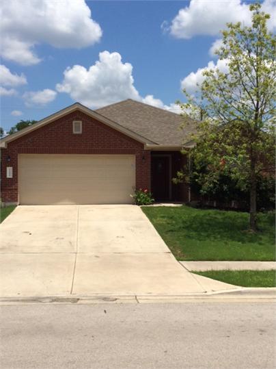 A well-maintained brick facade and verdant lawn c