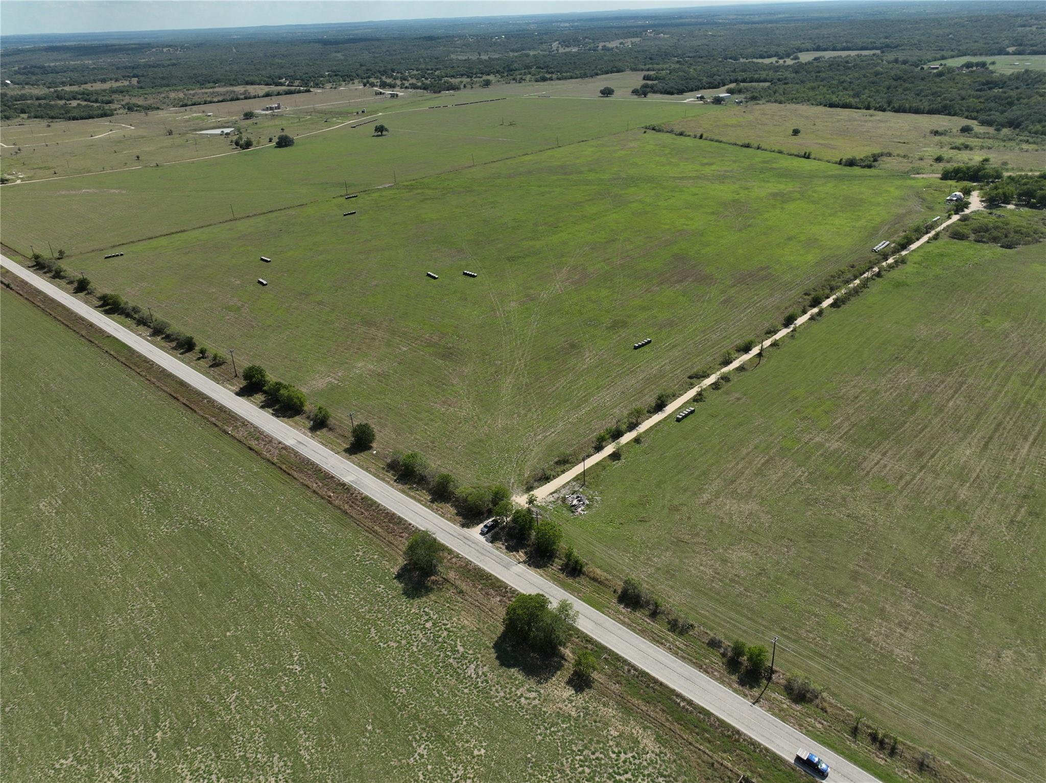 Vast green acreage awaits, featuring a long priva