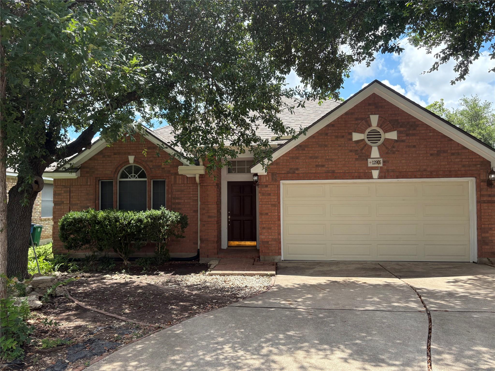 A classic brick exterior with an attached garage 