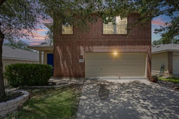 A charming brick residence awaits with an attache