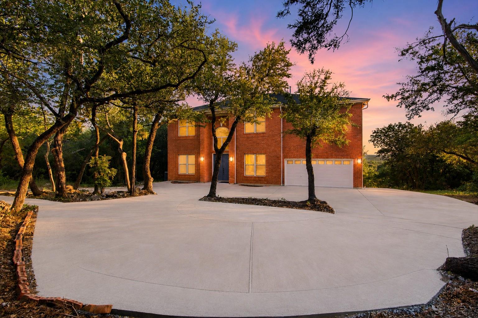 A classic brick exterior with a broad concrete dr