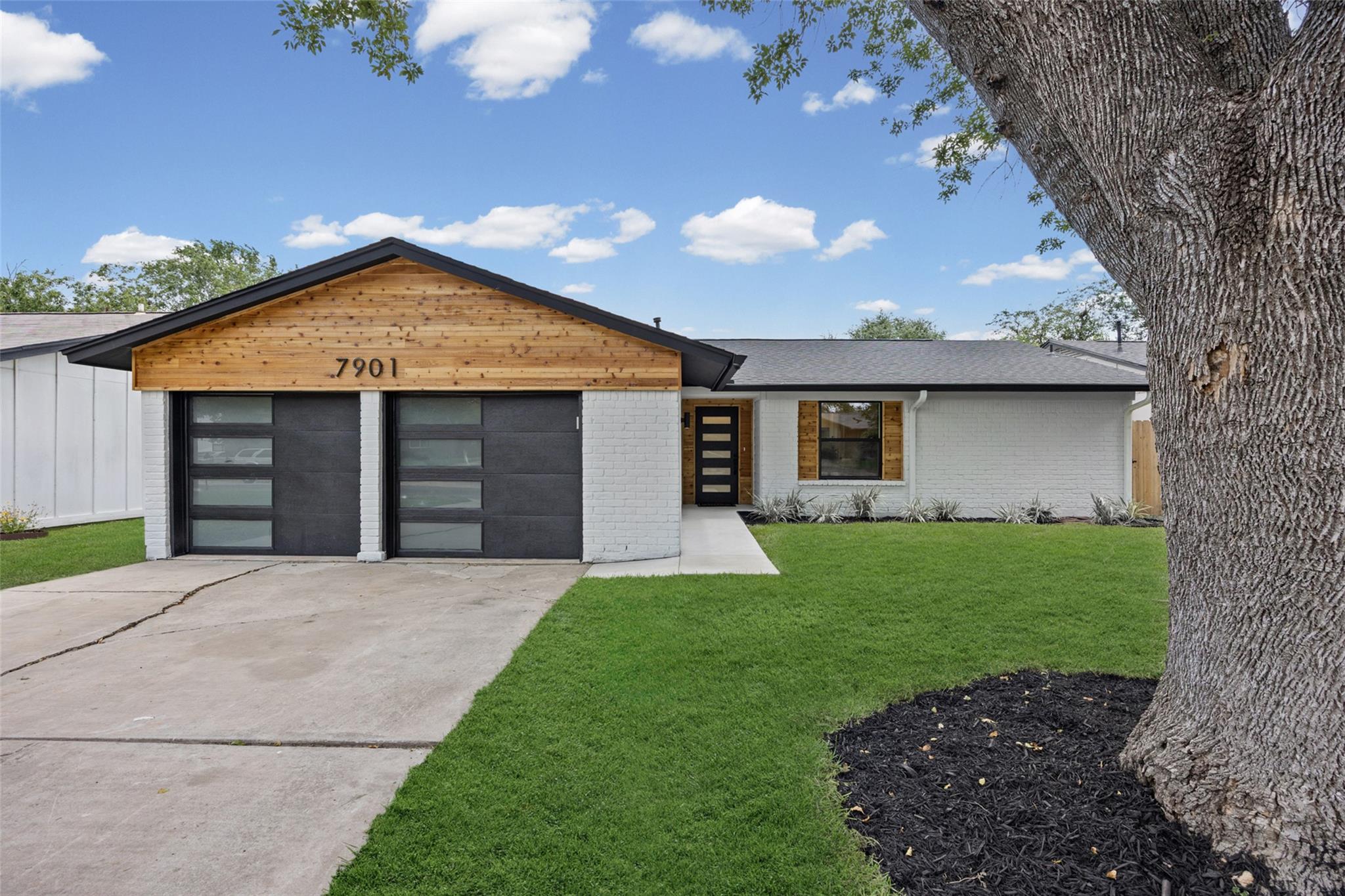 A striking modern facade with warm wood accents a
