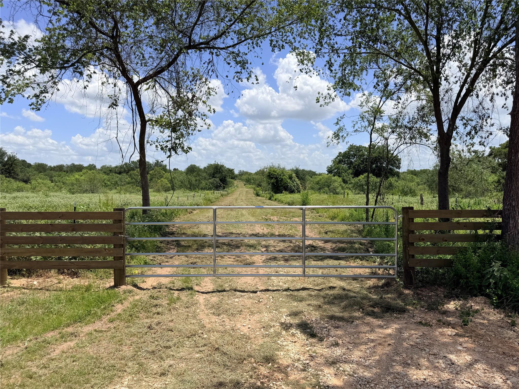 A private gate opens to a winding path through lu