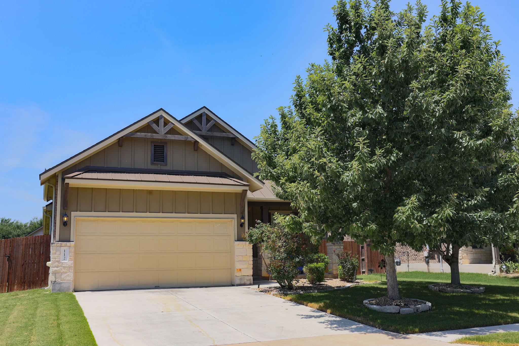 A welcoming facade featuring a two-car garage and