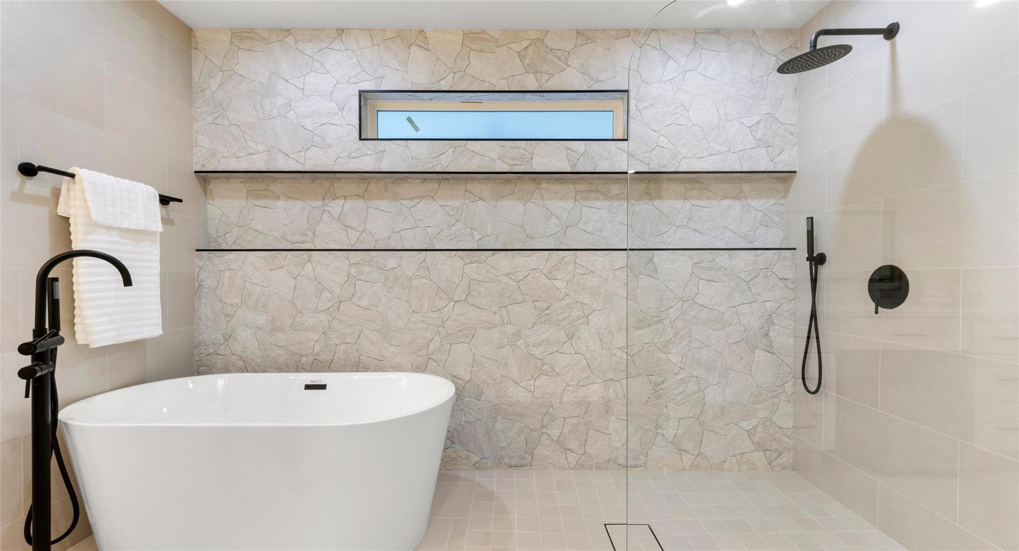 A refined bathroom featuring a sleek freestanding