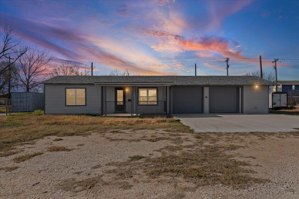 Single story home featuring driveway, a garage, c