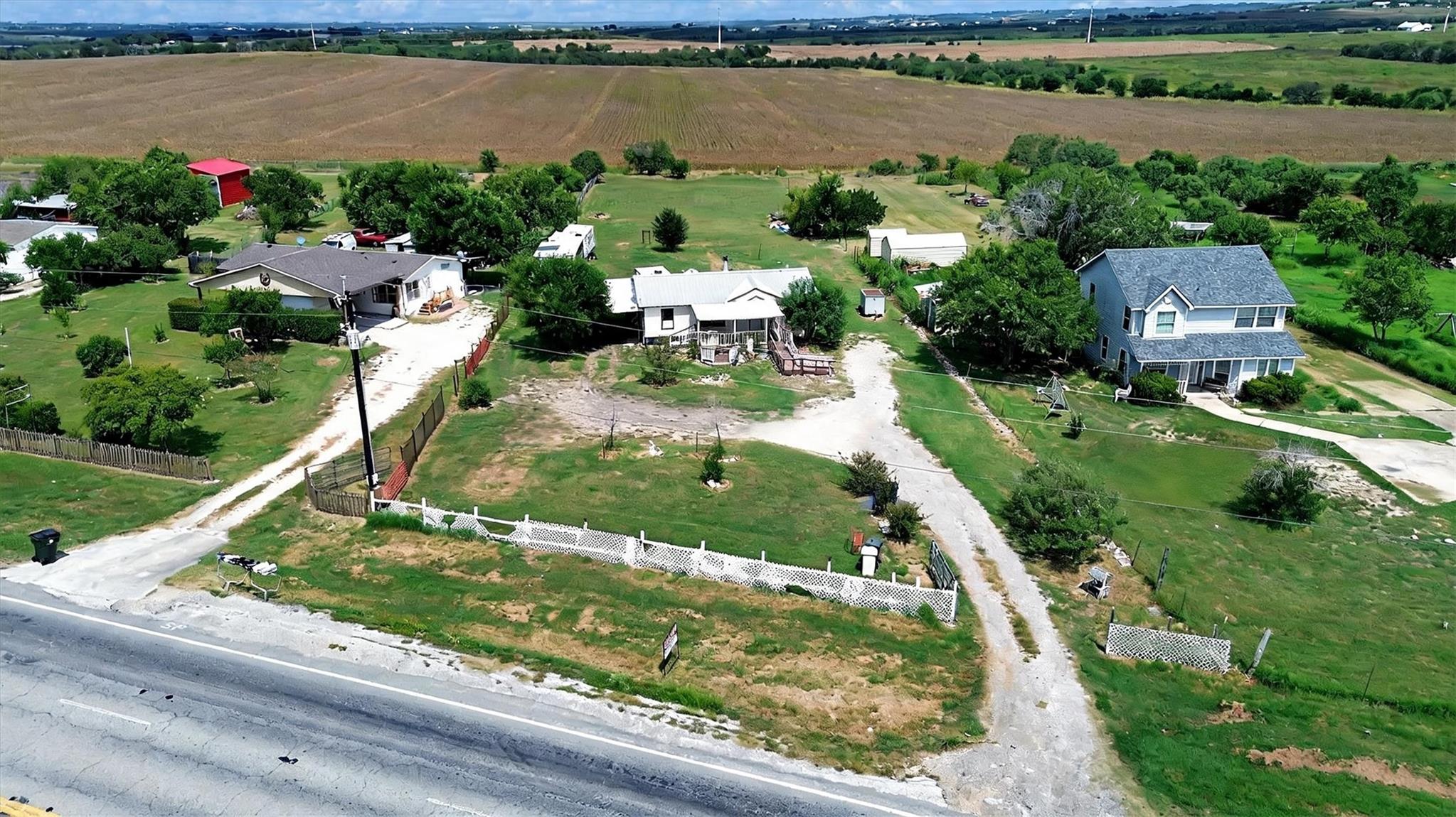 Rural homes nestled among lush trees and sprawlin