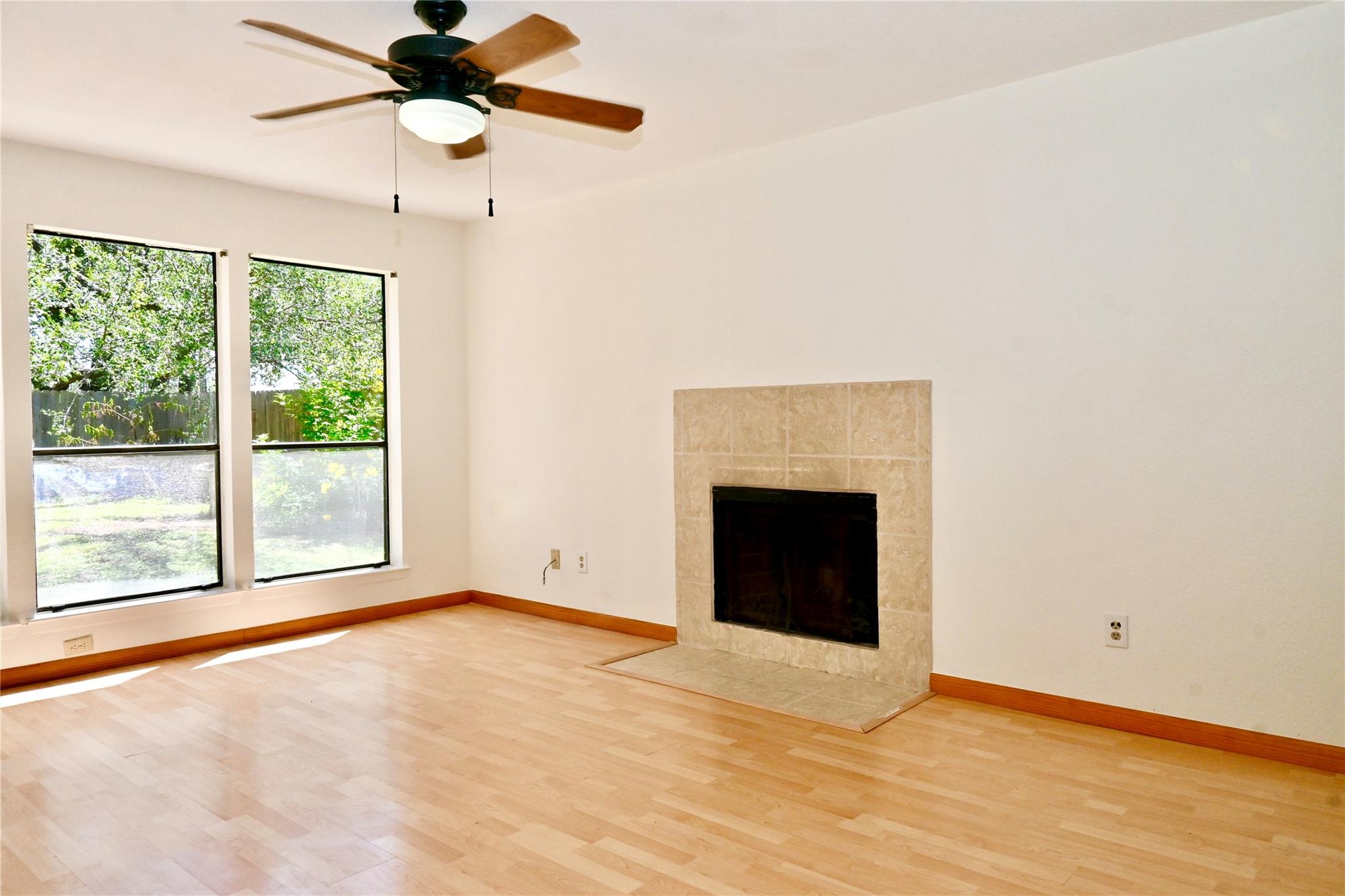 A bright living space features hardwood flooring,