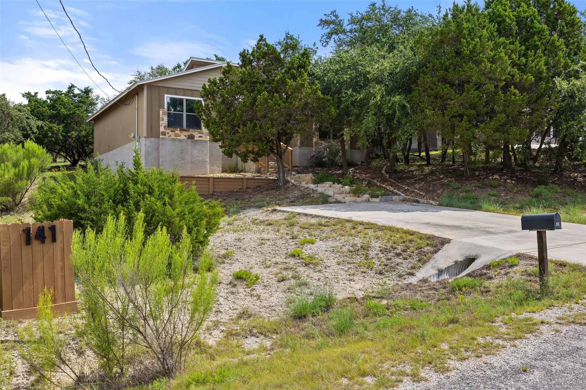 A private driveway leads to a secluded hillside d