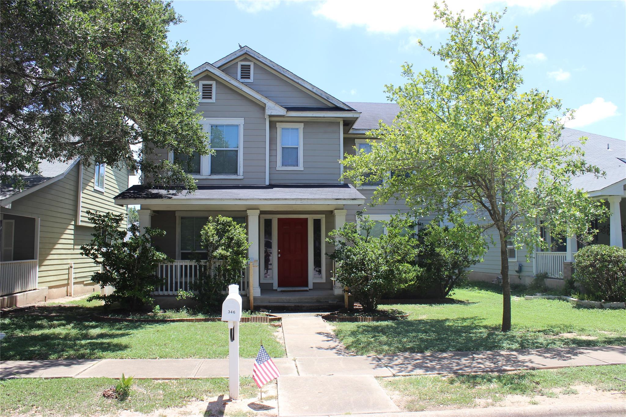 A welcoming front porch with white columns leads 