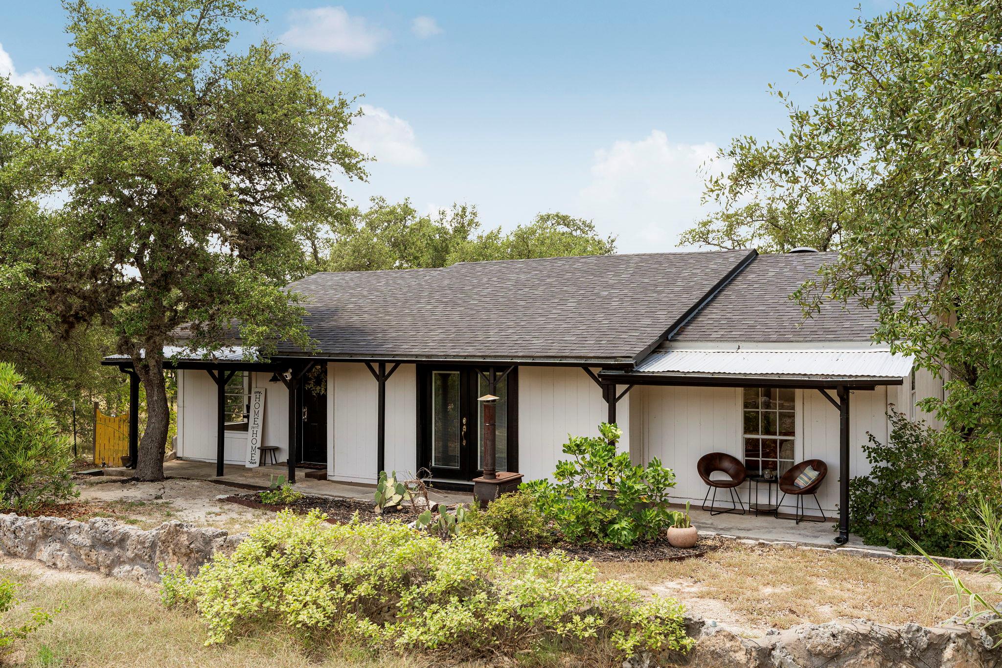 A charming white ranch-style residence featuring 