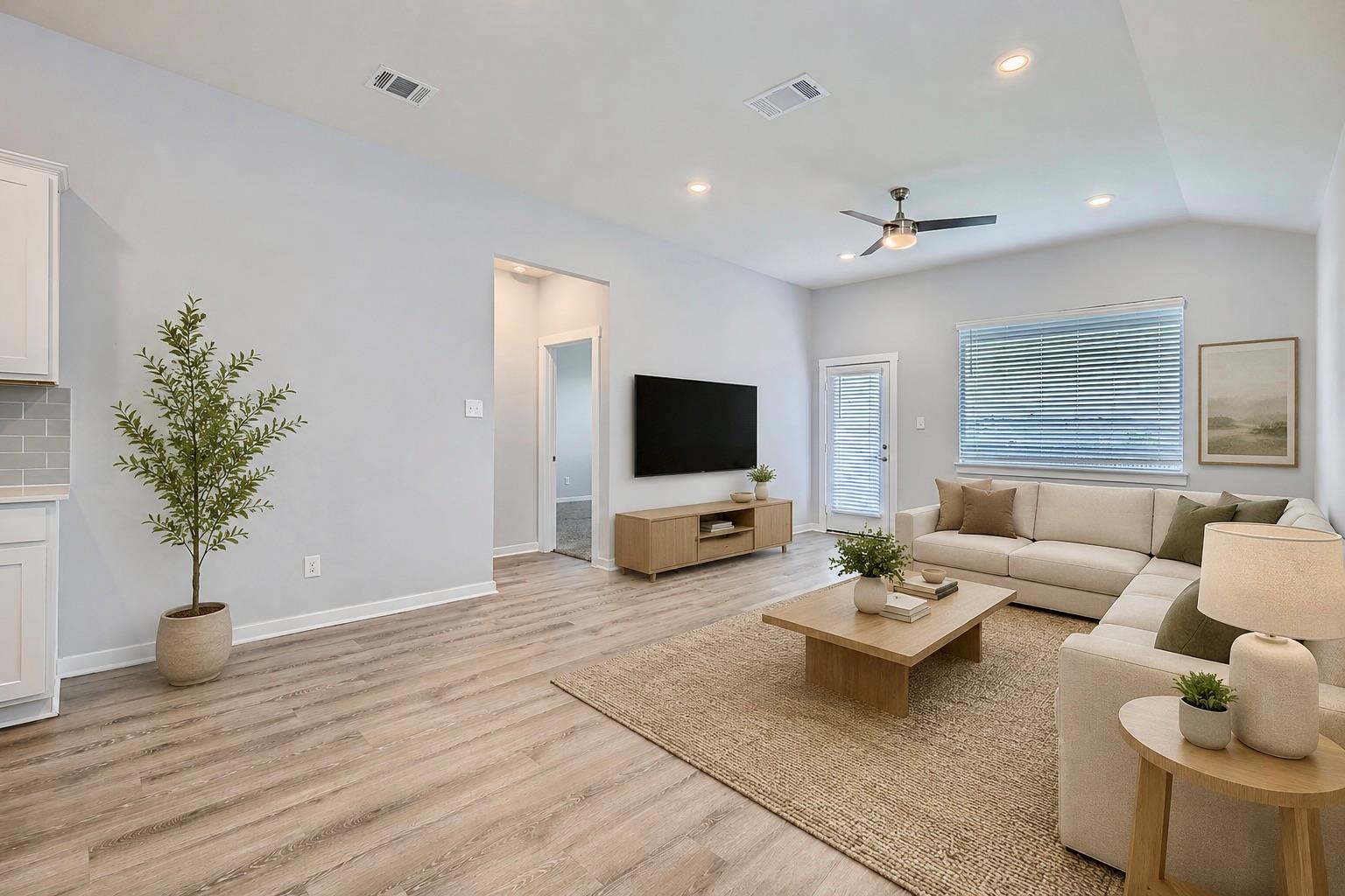 A living space with recessed lighting and light w