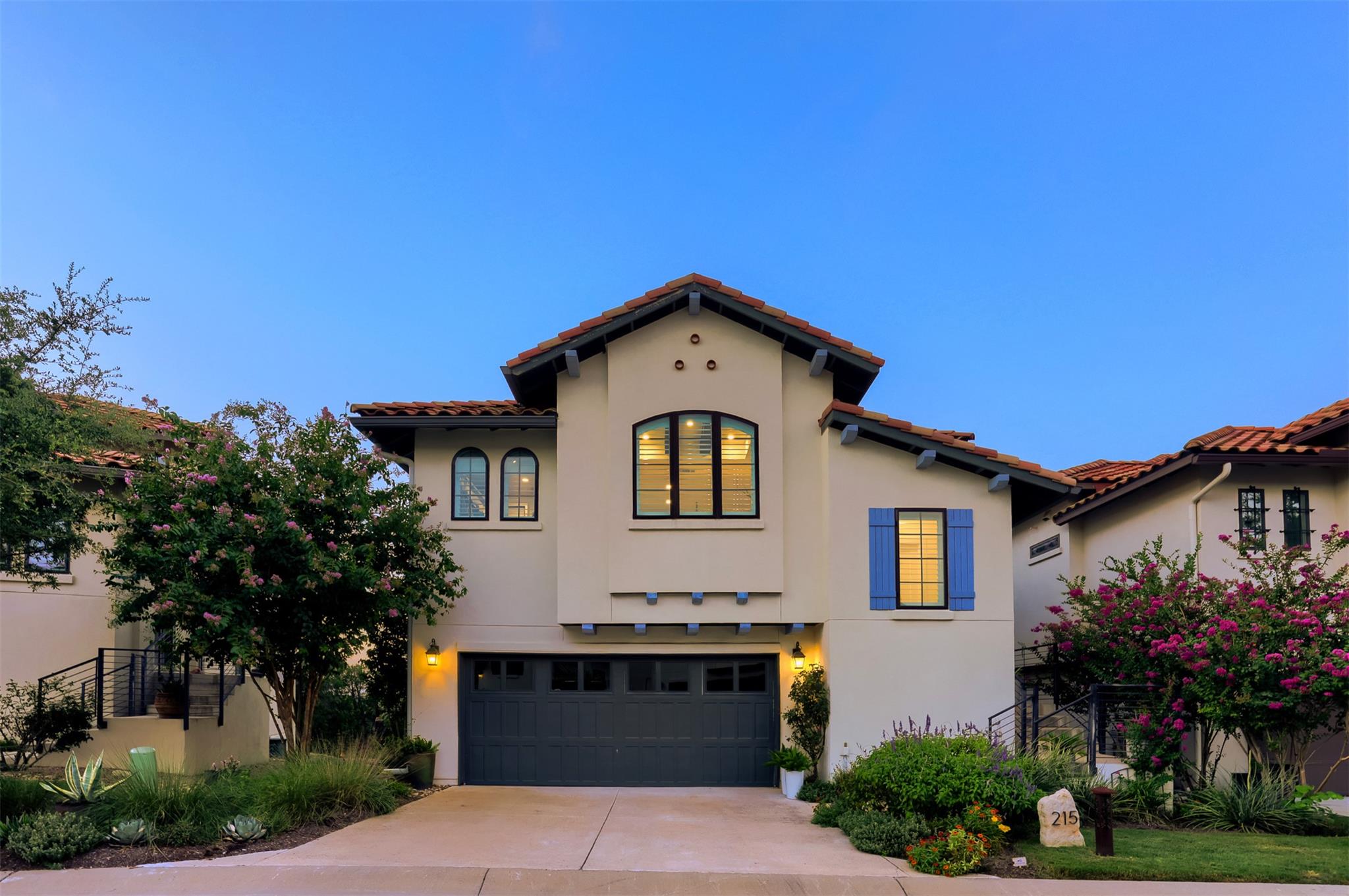 A terracotta-tiled roof crowns this stucco reside