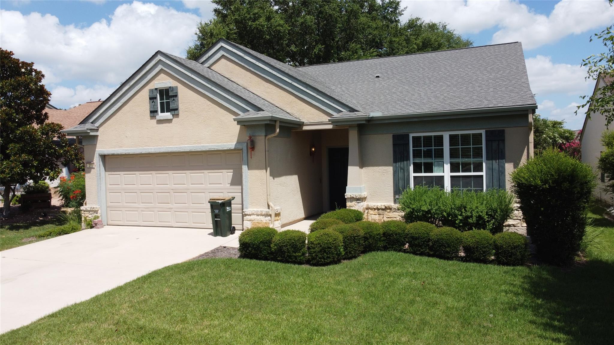 A well-maintained lawn introduces this inviting s