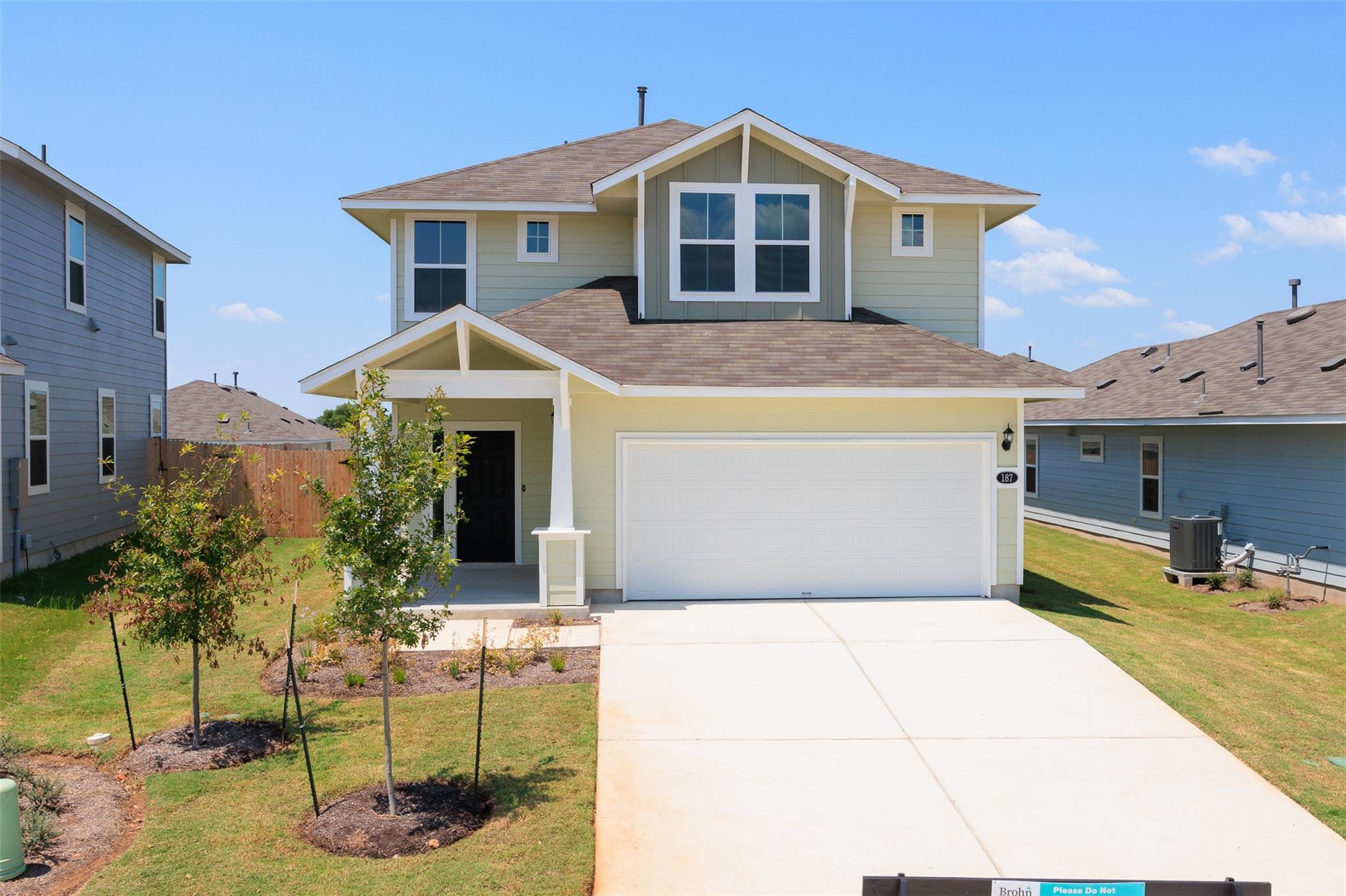 A newly built two-story residence features a welc