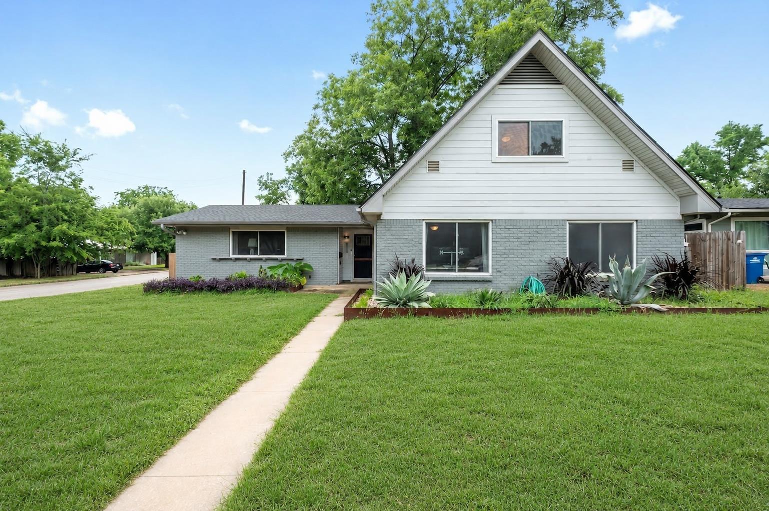 A neatly manicured lawn guides guests to this cha