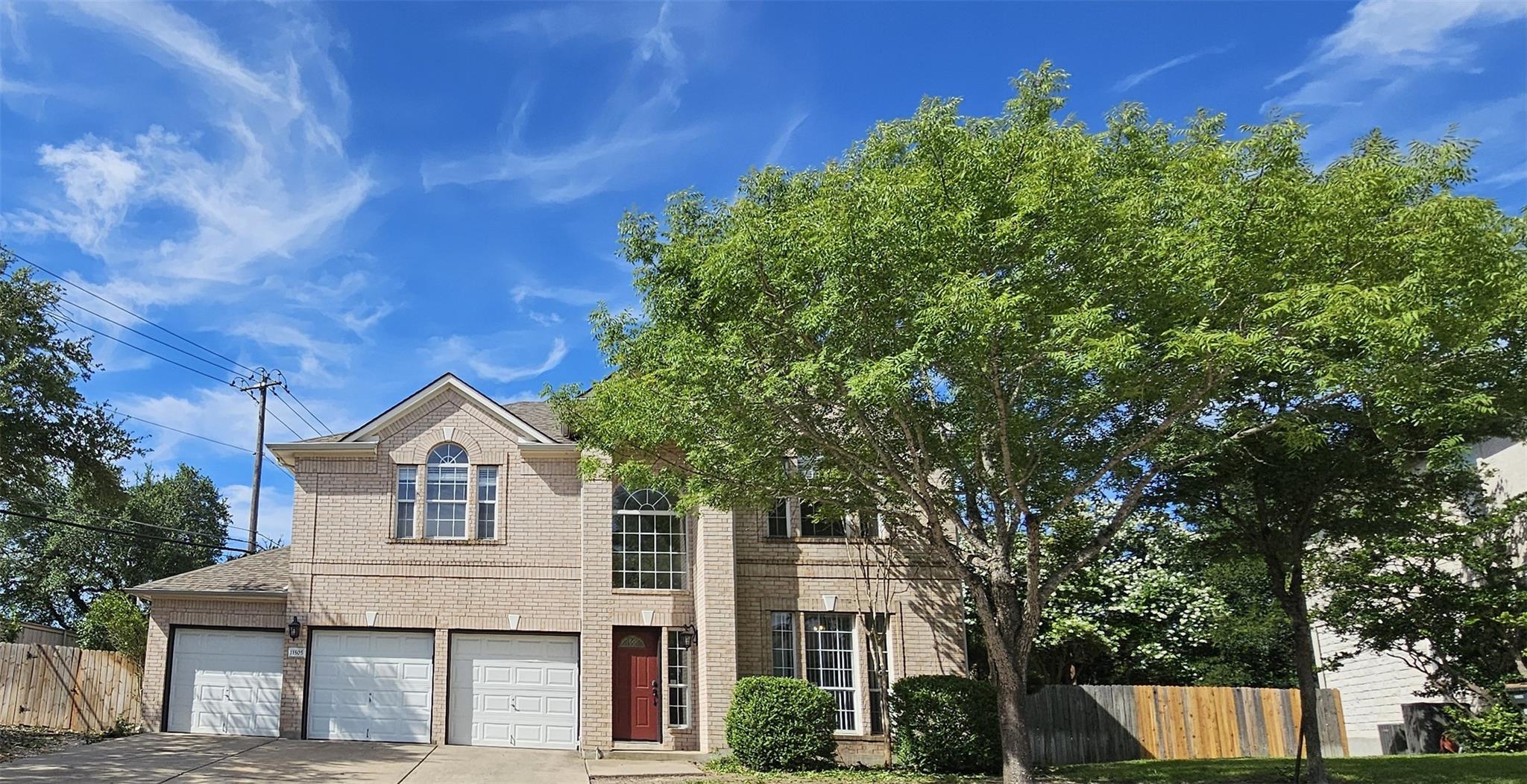 A classic brick two-story residence presents a gr