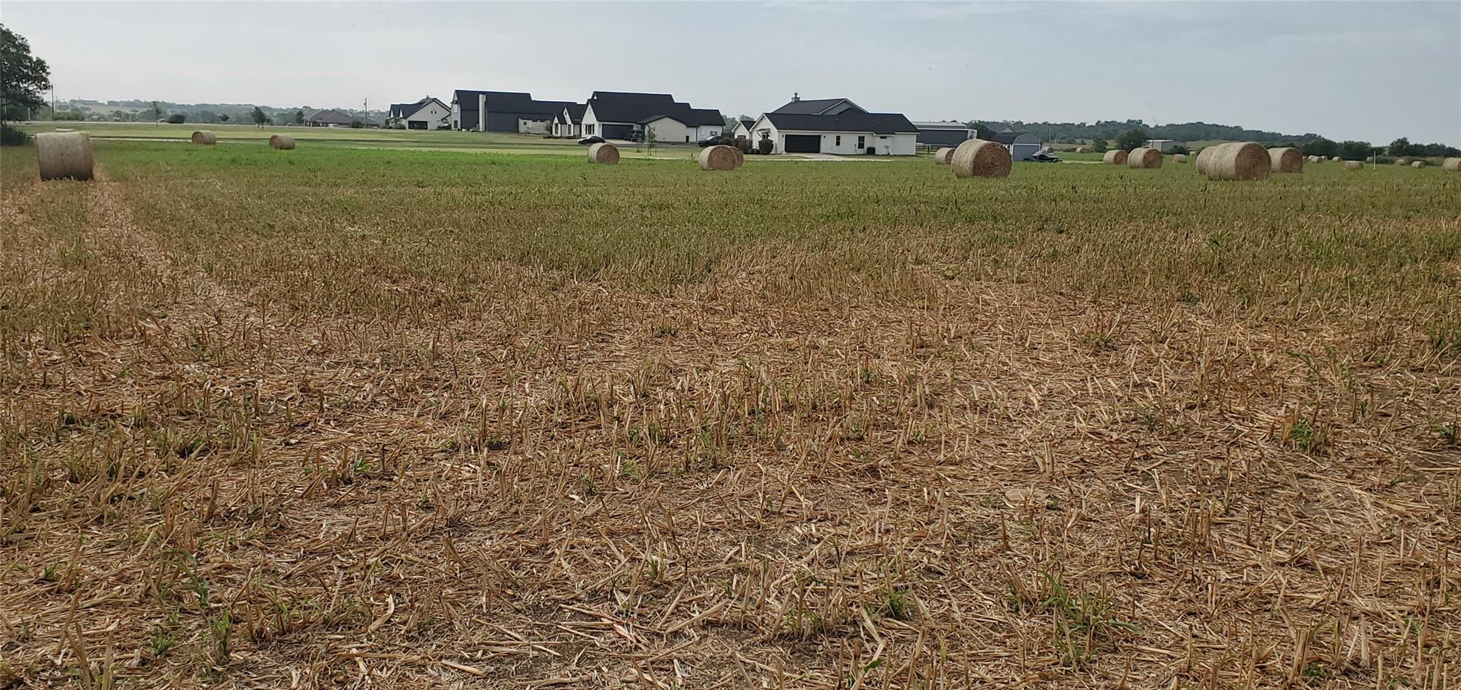 Cultivated fields with hay bales offer a pastoral