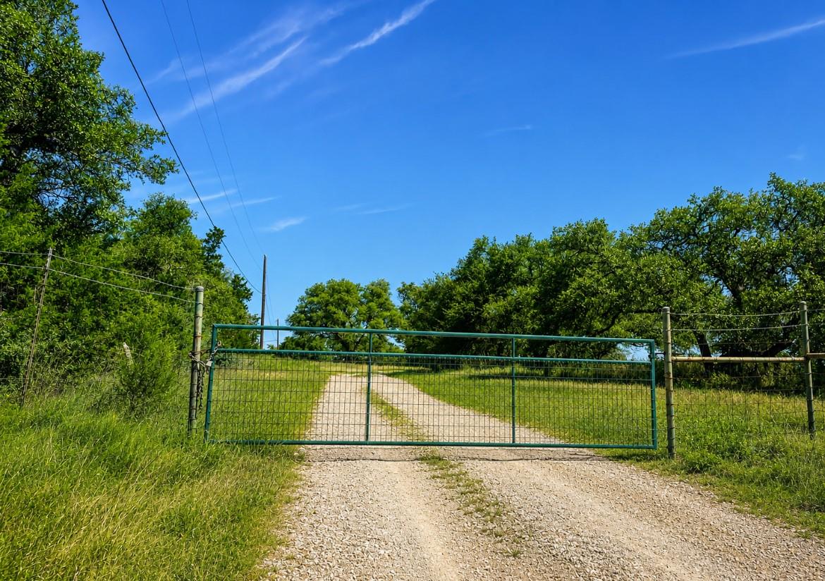 A private gravel driveway leads to an expansive, 