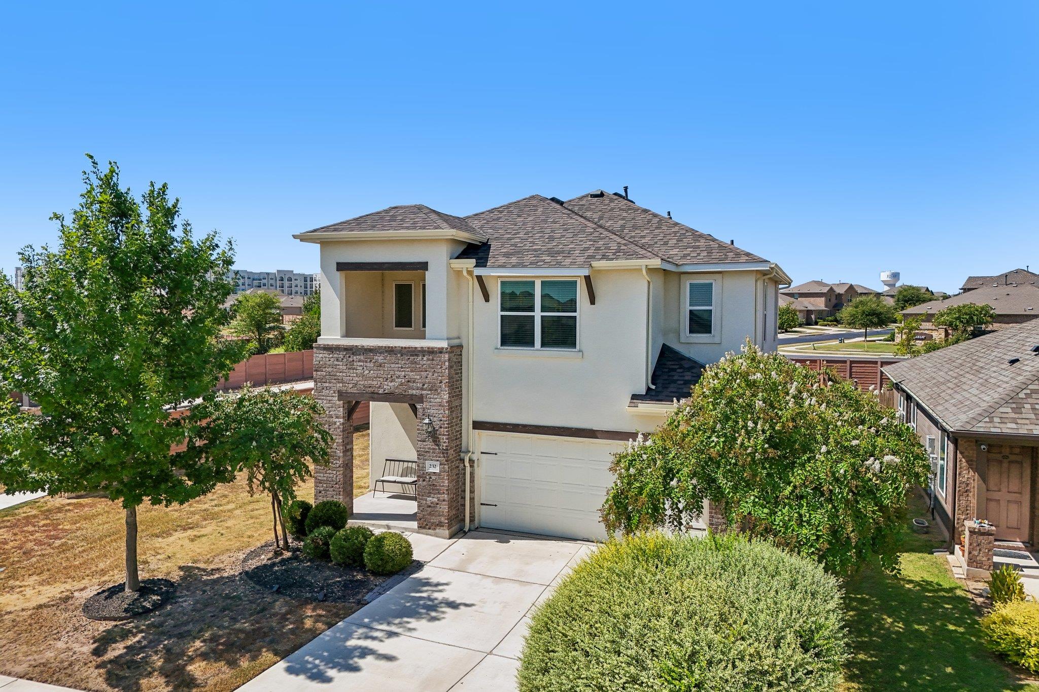 An inviting exterior features a concrete driveway