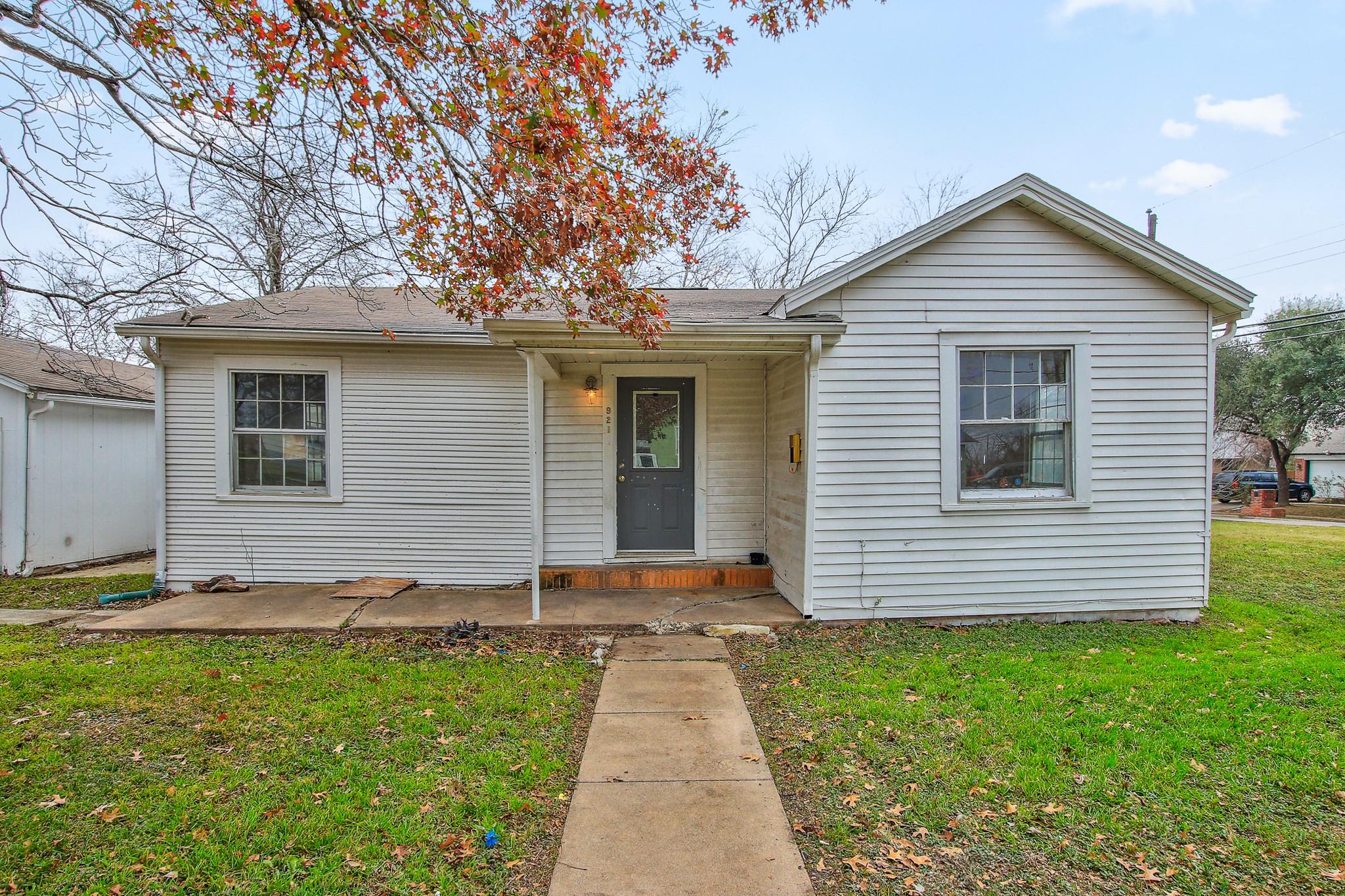 A classic facade with a small front porch invites
