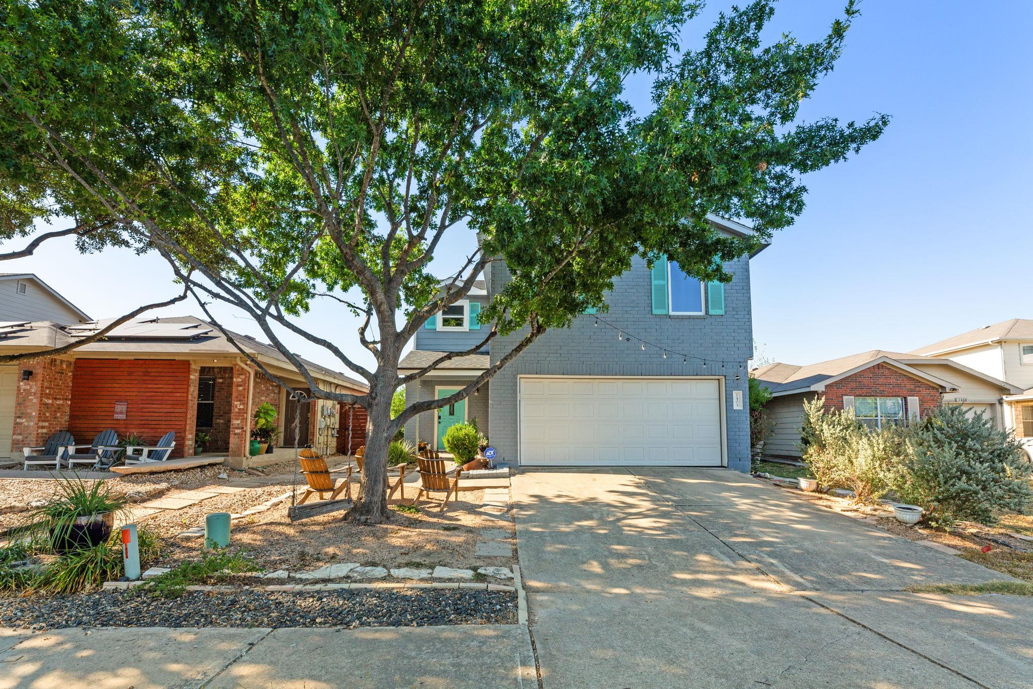 A welcoming front exterior features a driveway le