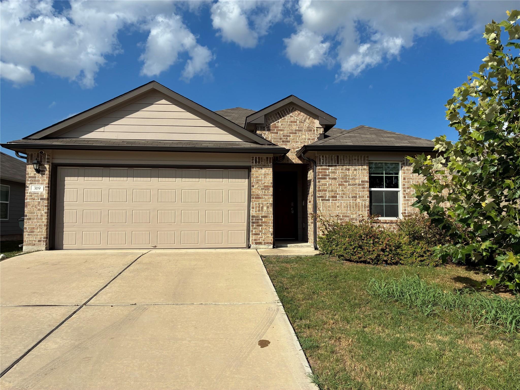 A classic brick facade and integrated garage offe