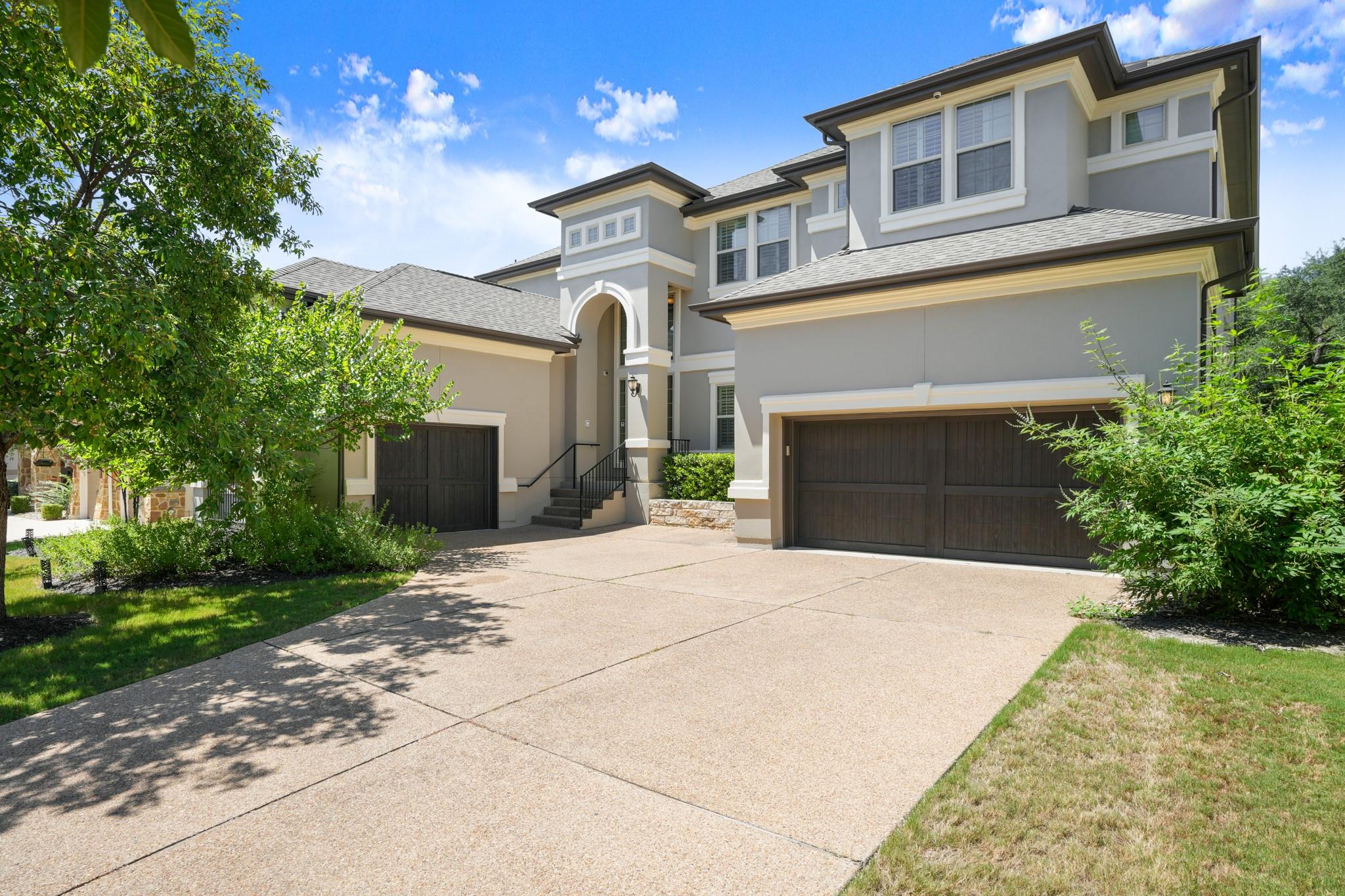 Elegant stucco facade welcomes with dual garages 